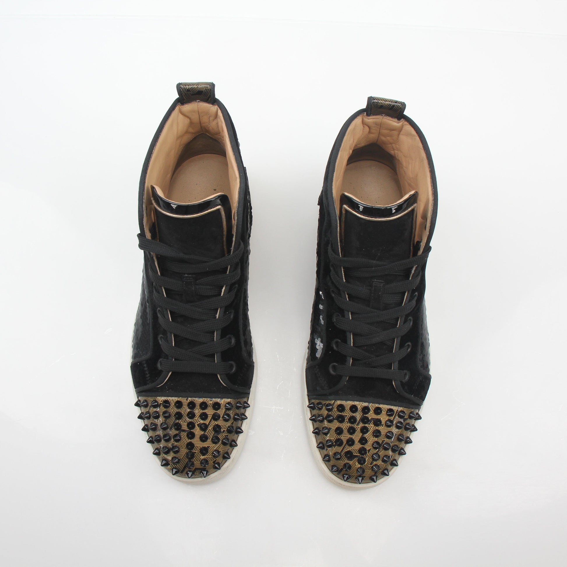 Christian Louboutin Lou Spikes Orlato high-top sneakers in black with red sole and spike details, displayed on a white background.