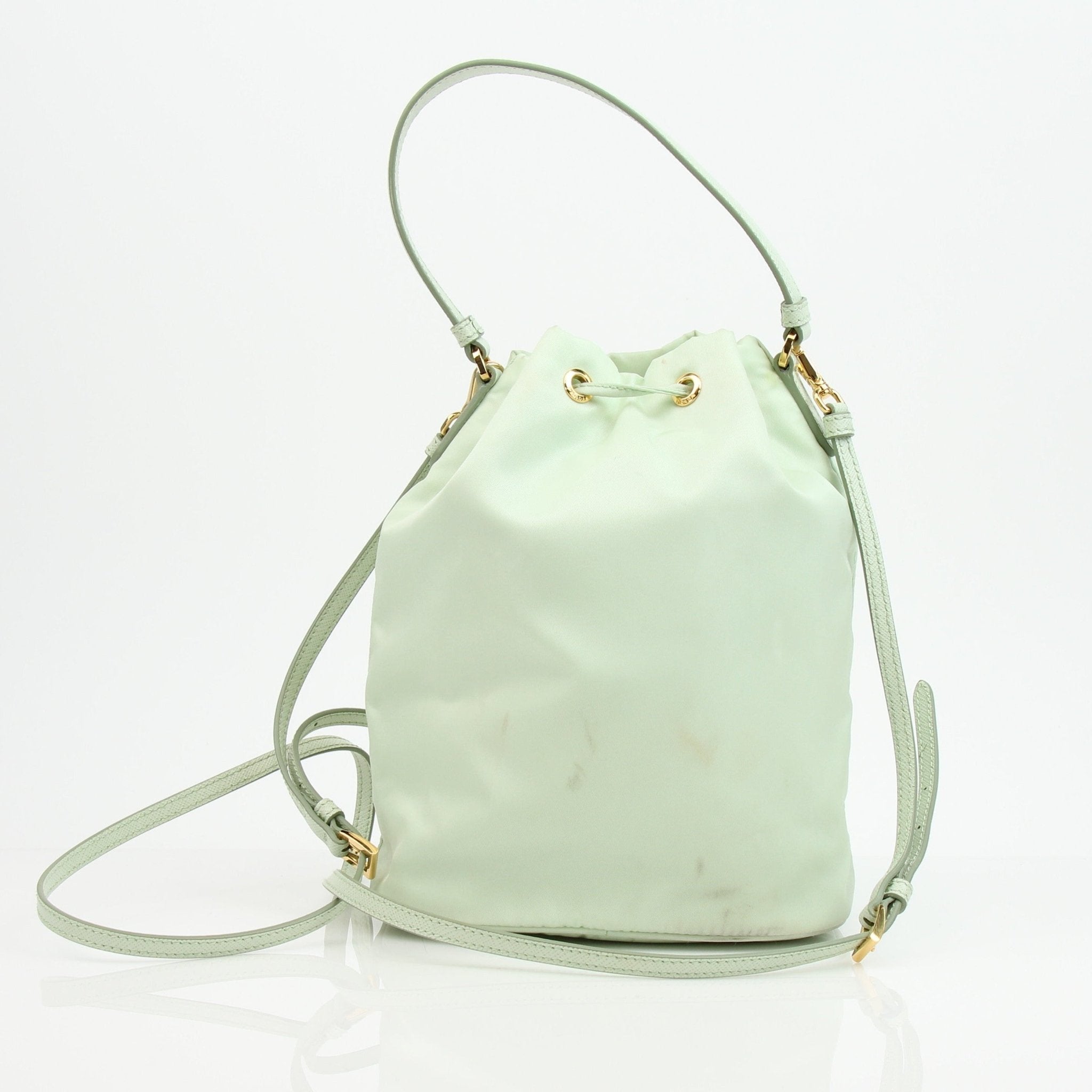Prada nylon drawstring handbag with adjustable straps and sleek design, featuring the iconic Prada logo on the front.