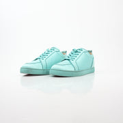 Christian Louboutin turquoise Rantulow Orlato low-top sneakers with gold accents and signature red soles, displayed on a white background.