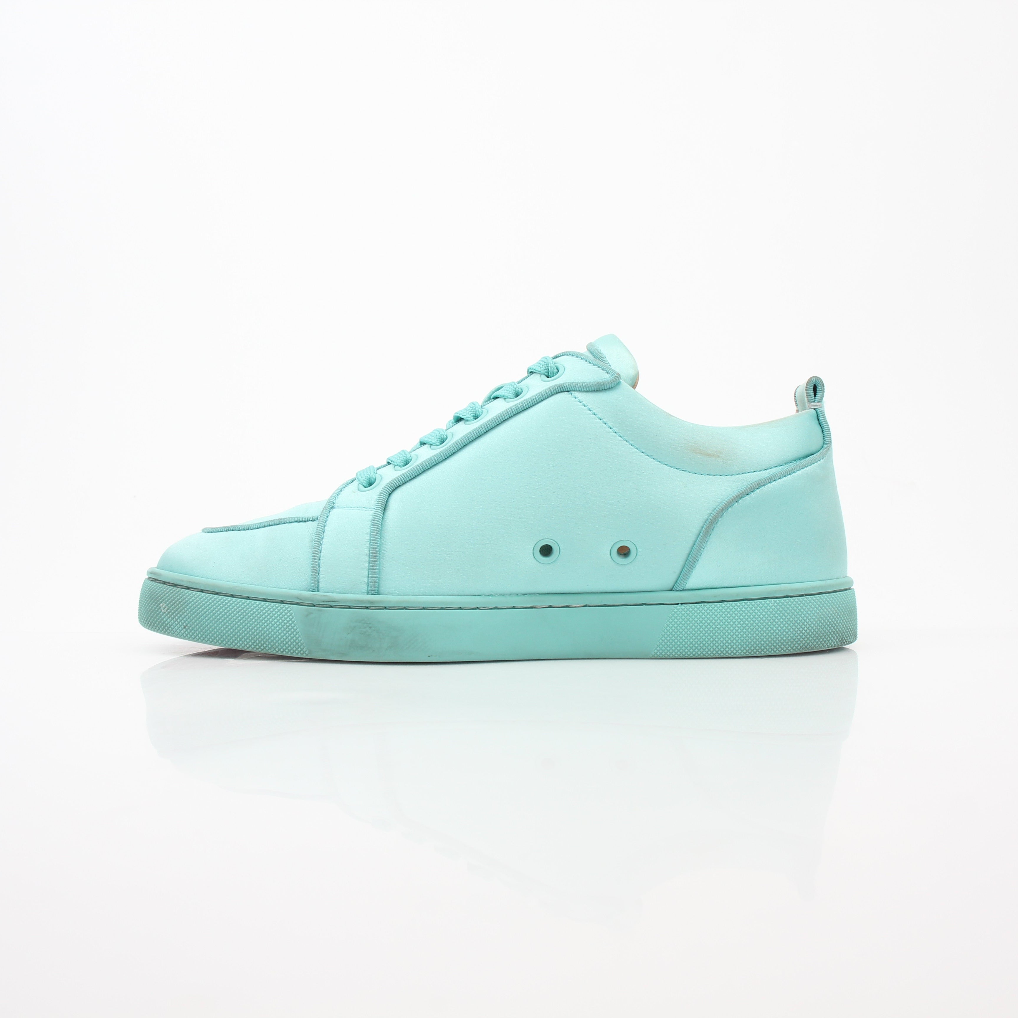 Christian Louboutin Turquoise Rantulow Orlato low-top sneakers featuring bold color and stylish design, displayed on a white background.