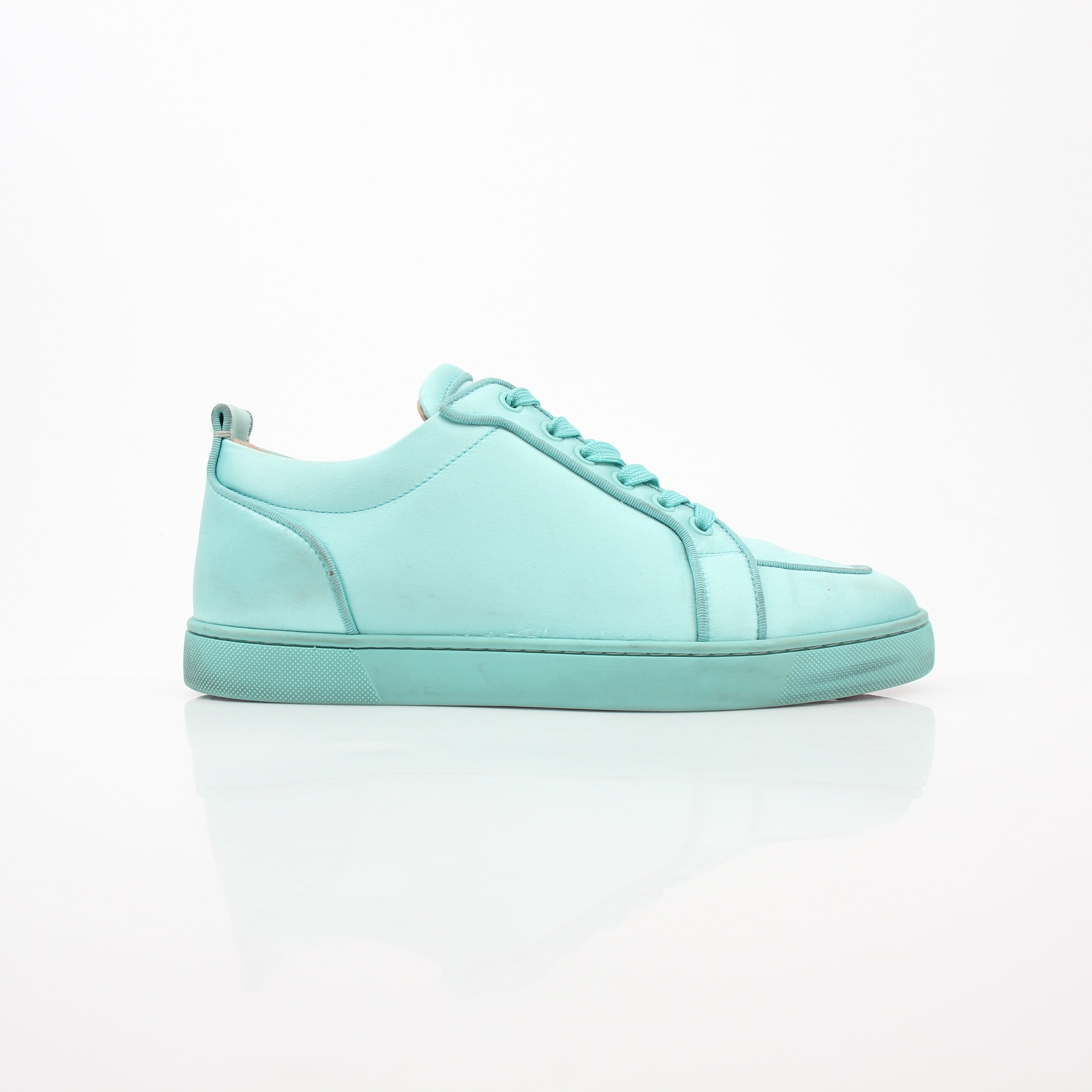 Christian Louboutin Turquoise Rantulow Orlato low-top sneakers with signature red soles and stylish design.