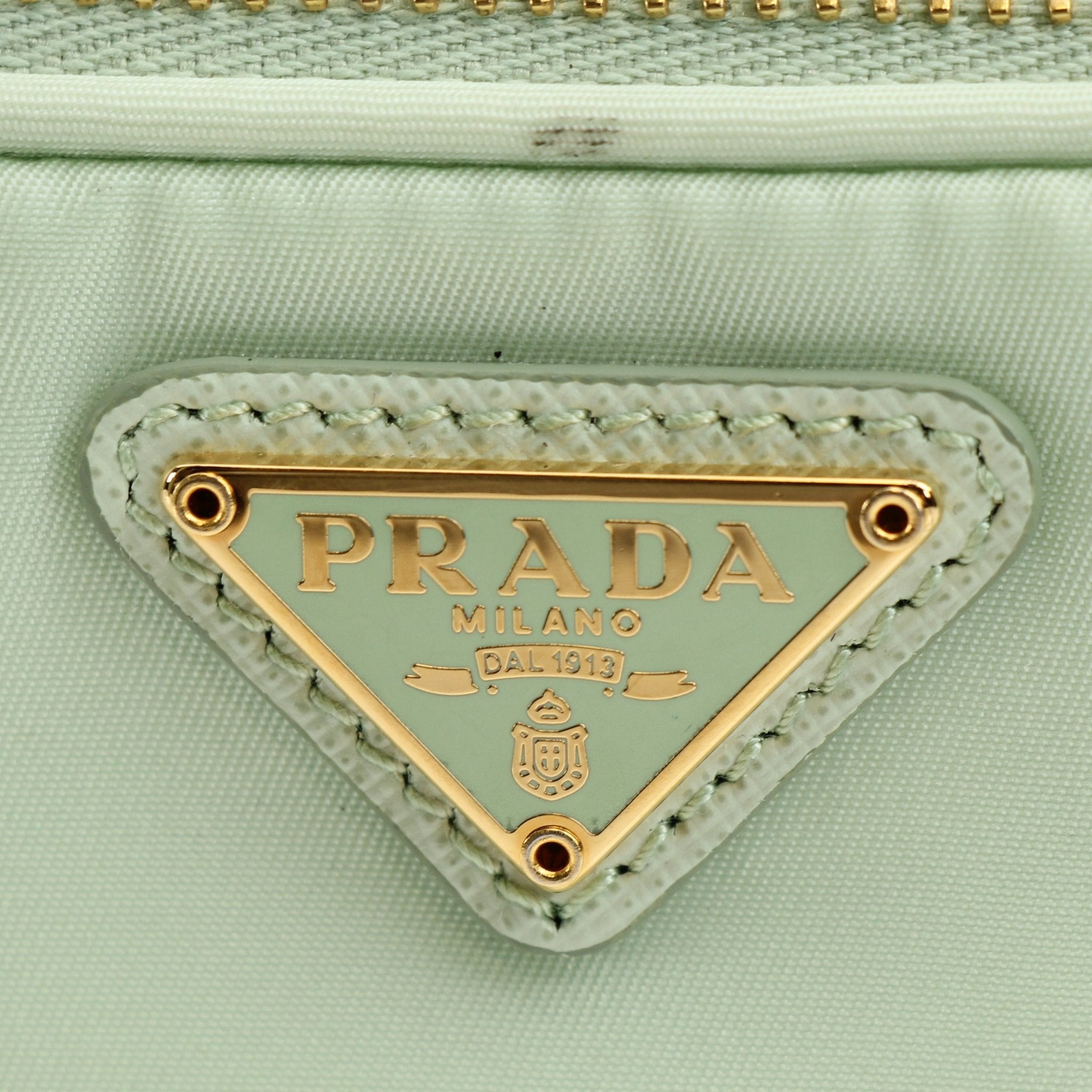 Prada nylon drawstring handbag with adjustable straps and sleek design, featuring the Prada logo on the front.