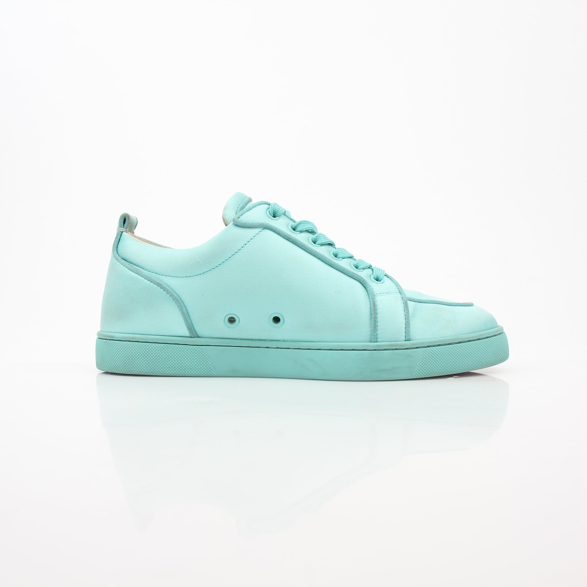 Christian Louboutin turquoise Rantulow Orlato low-top sneakers with signature red soles and stylish design, displayed on a clean surface.