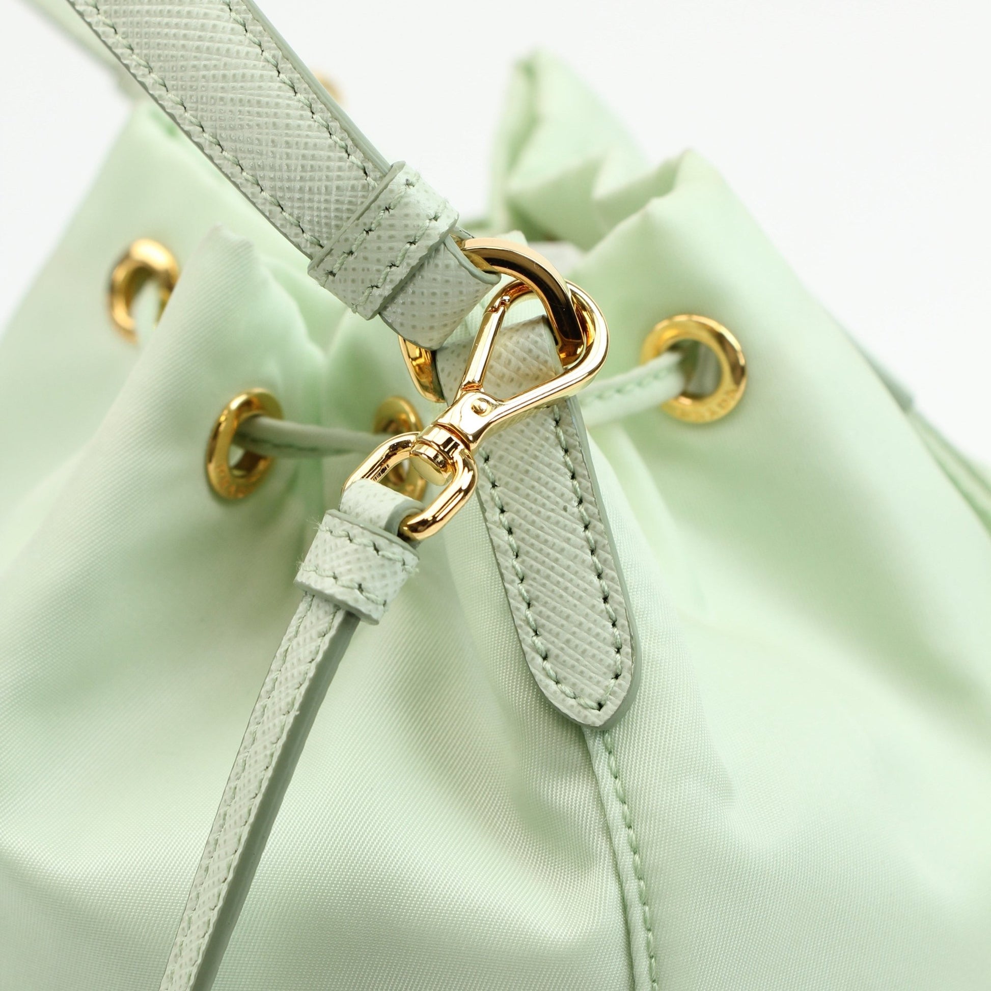 Prada nylon drawstring handbag with adjustable straps and sleek design, showcasing a stylish and functional accessory.