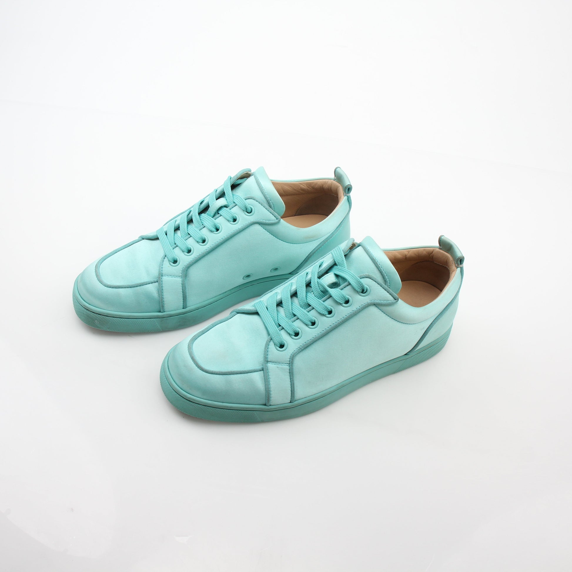 Christian Louboutin turquoise Rantulow Orlato low-top sneakers for women, featuring distinctive design and signature red sole detail.