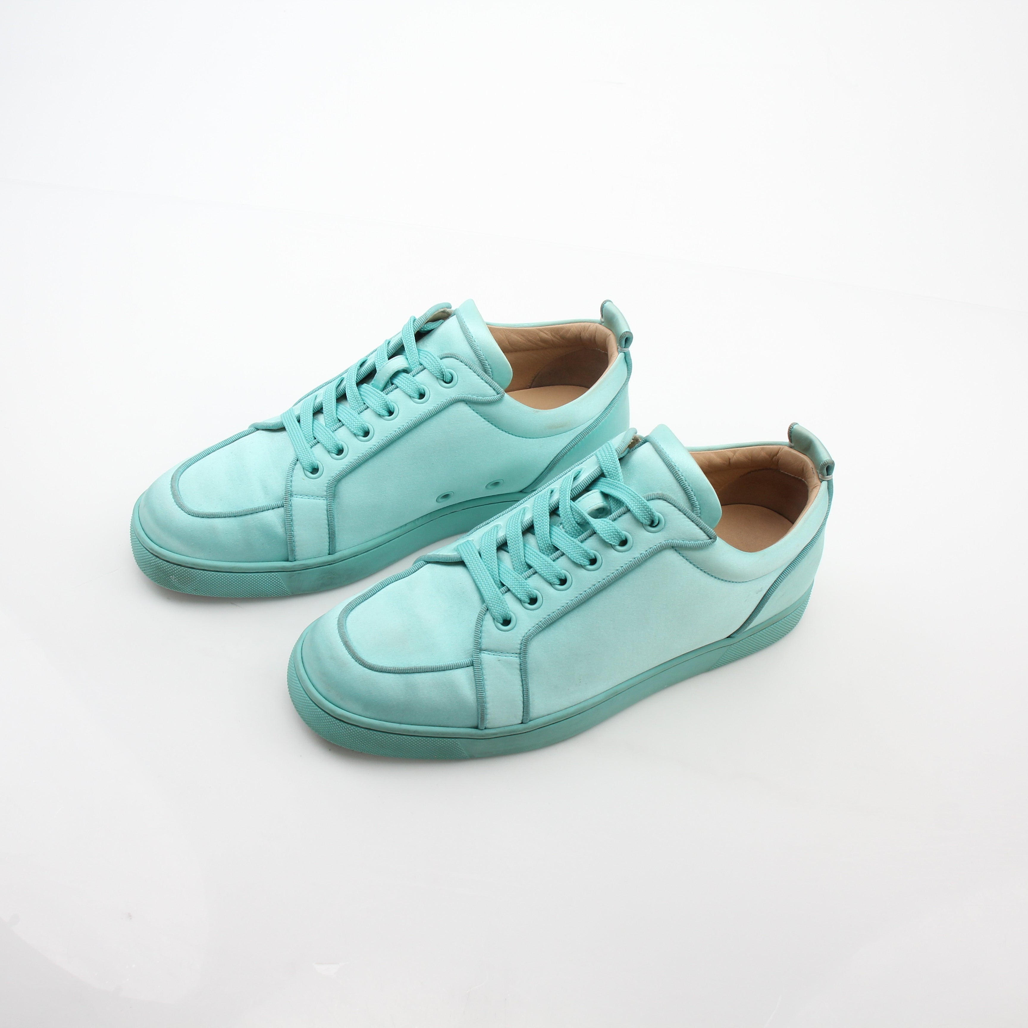 Christian Louboutin turquoise Rantulow Orlato low-top sneakers for women, featuring distinctive design and signature red sole detail.
