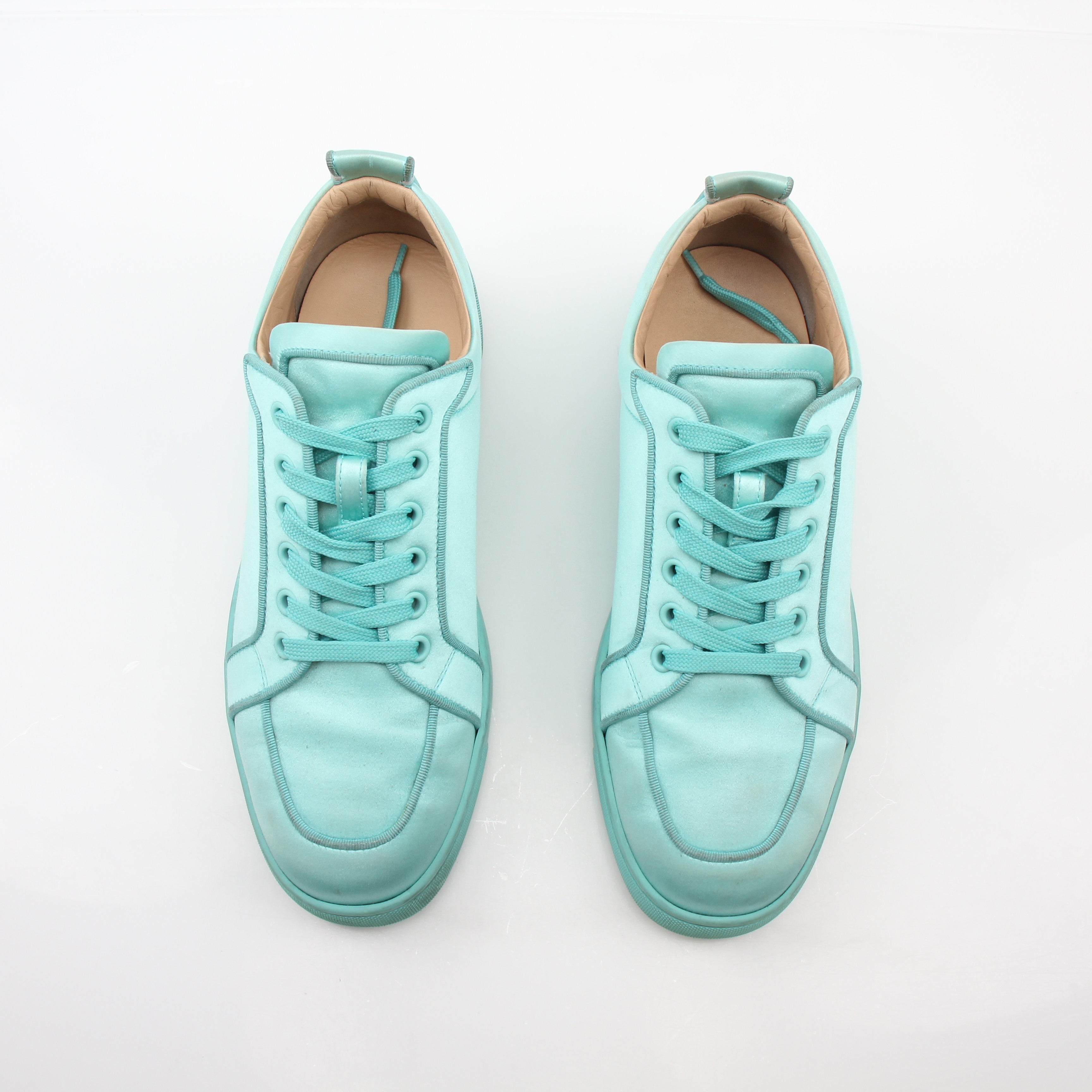 Christian Louboutin turquoise Rantulow Orlato low-top sneakers featuring signature red sole and stylish design, shown from the side.