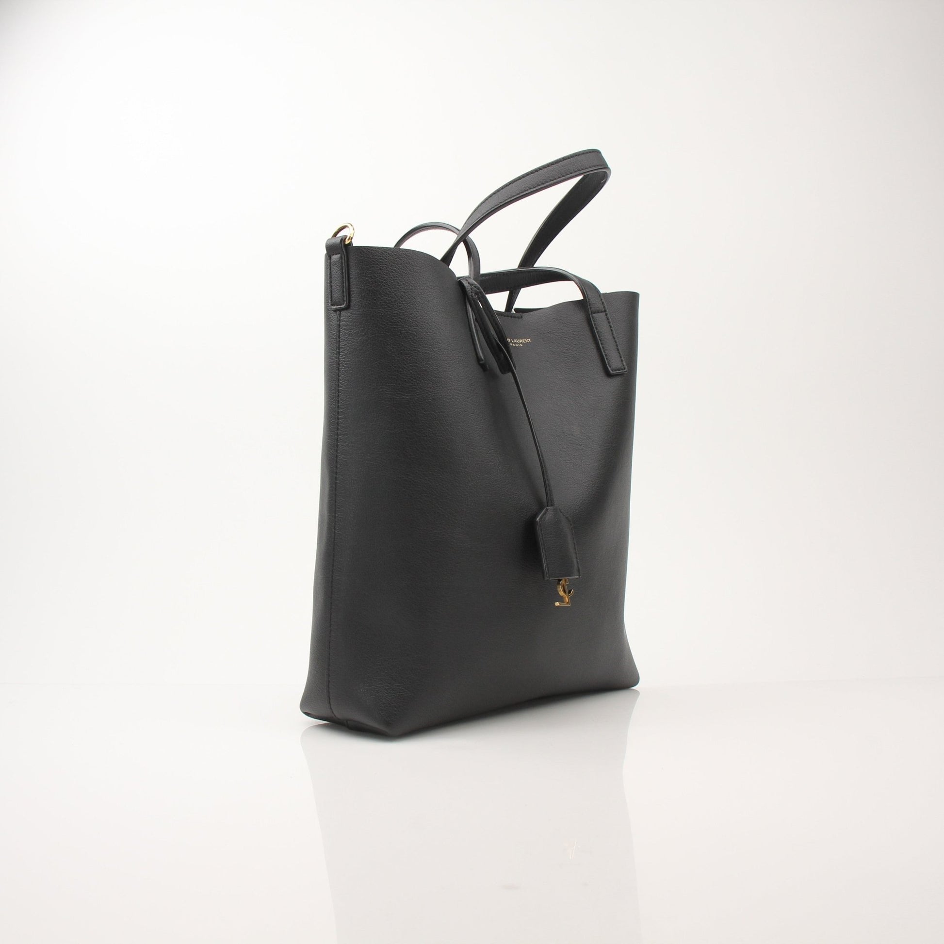 Gold & Beyond Saint Laurent Toy Shopping Tote handbag with beige and black color block design, featuring sturdy handles and logo details.