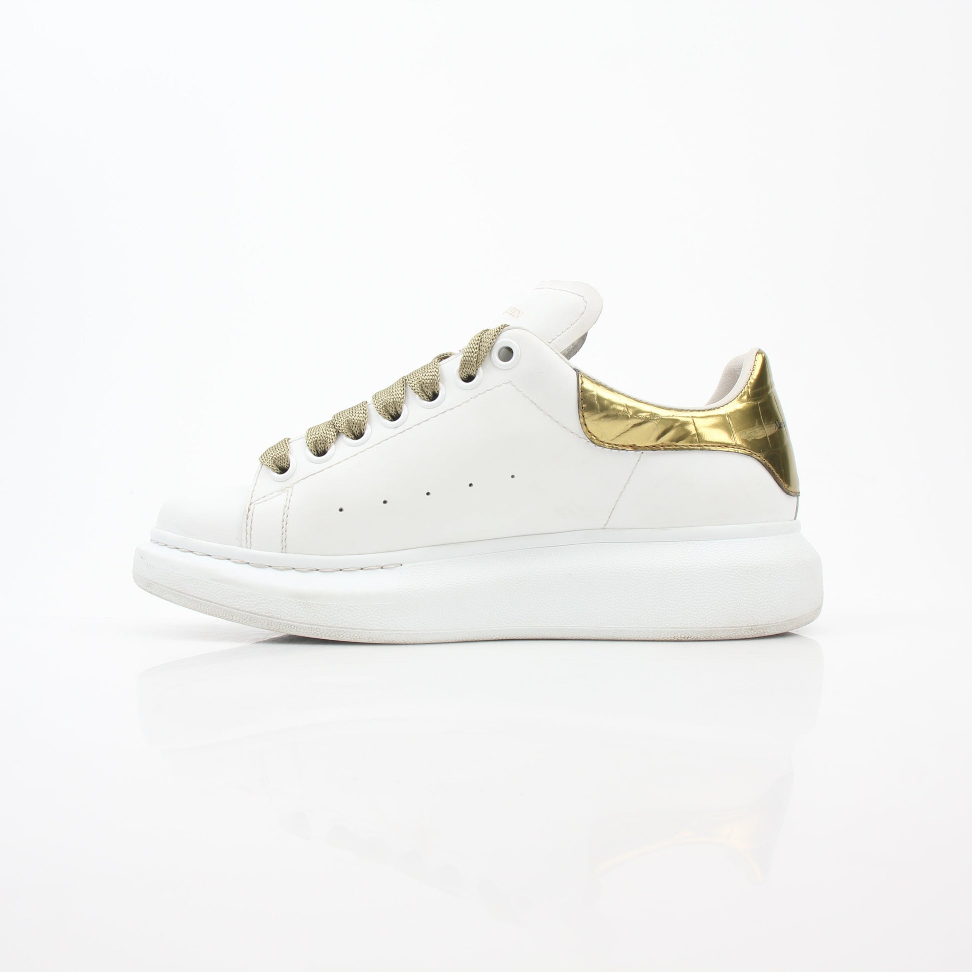 Alexander McQueen white gold oversized low-top sneakers, stylish shoes with a sleek design and chunky sole, from Gold & Beyond.