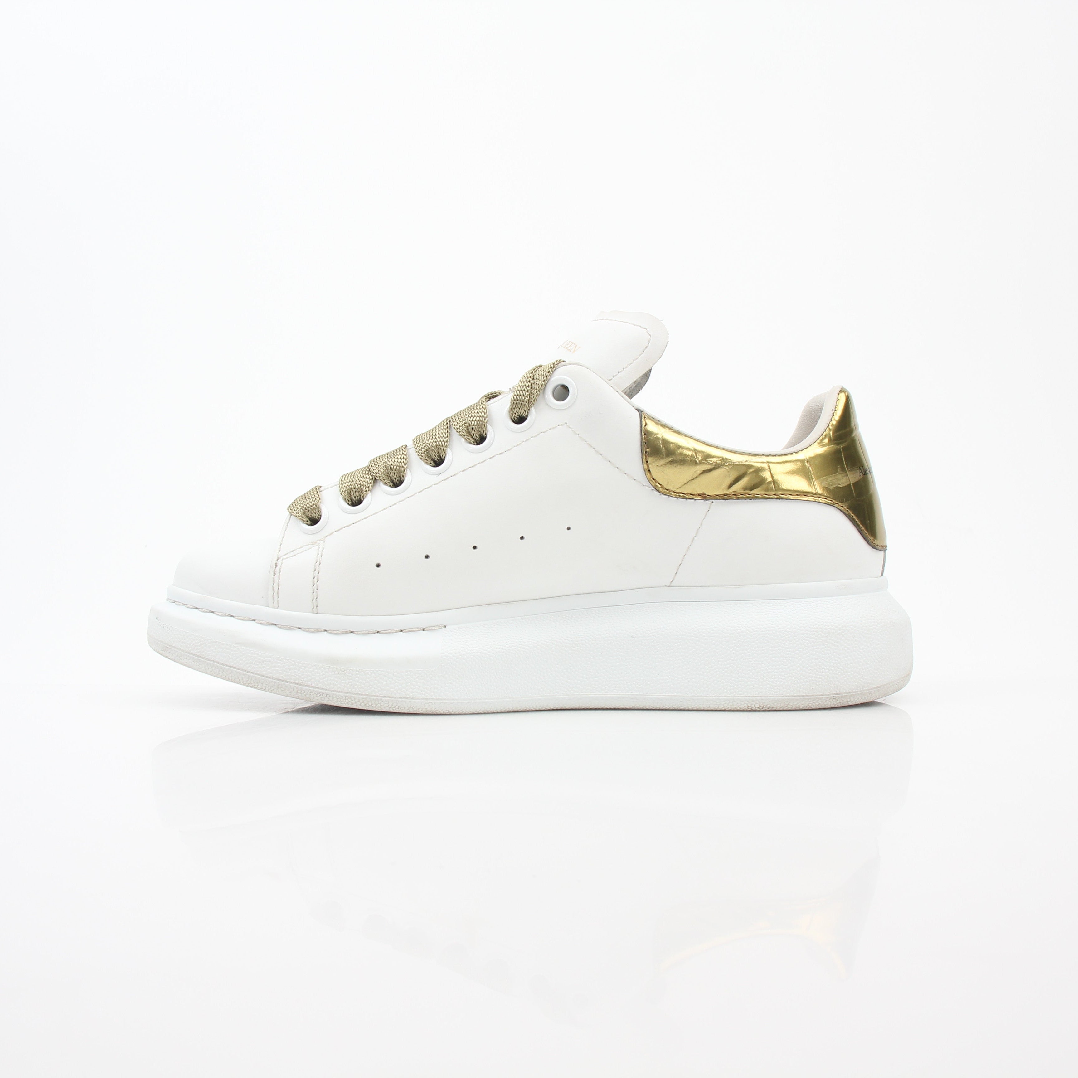Alexander McQueen white gold oversized low-top sneakers, stylish shoes with a sleek design and chunky sole, from Gold & Beyond.