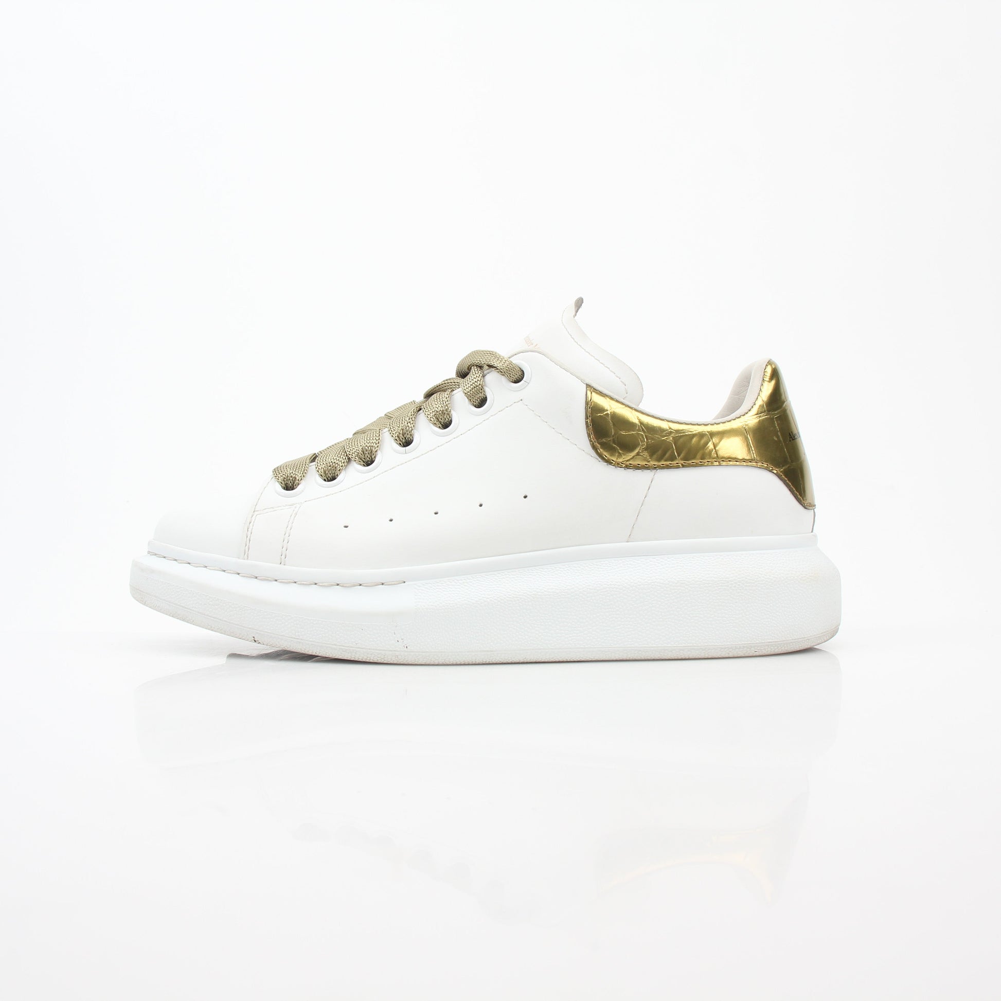 Alexander McQueen white gold oversized low-top sneakers by Gold & Beyond, featuring a sleek design and chunky sole.