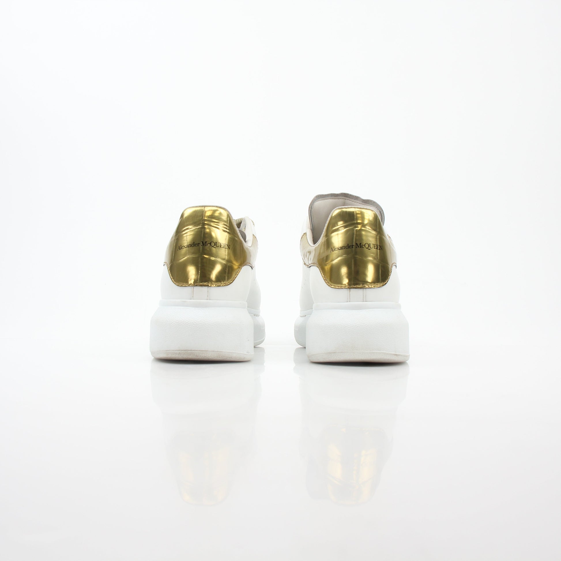 Alexander McQueen white gold oversized low-top sneakers by Gold & Beyond, featuring sleek design and stylish sneakers.