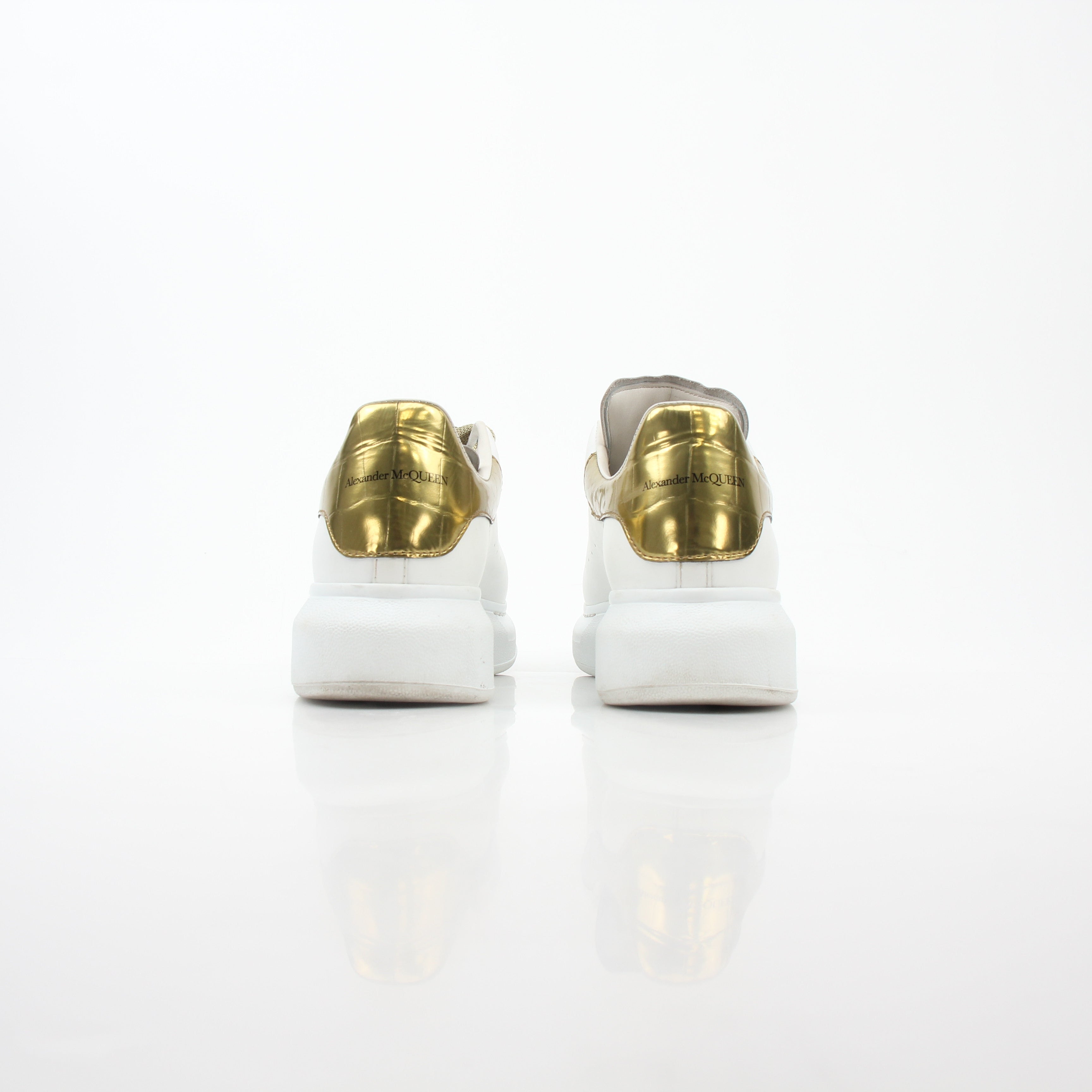 Alexander McQueen white gold oversized low-top sneakers by Gold & Beyond, featuring sleek design and stylish sneakers.