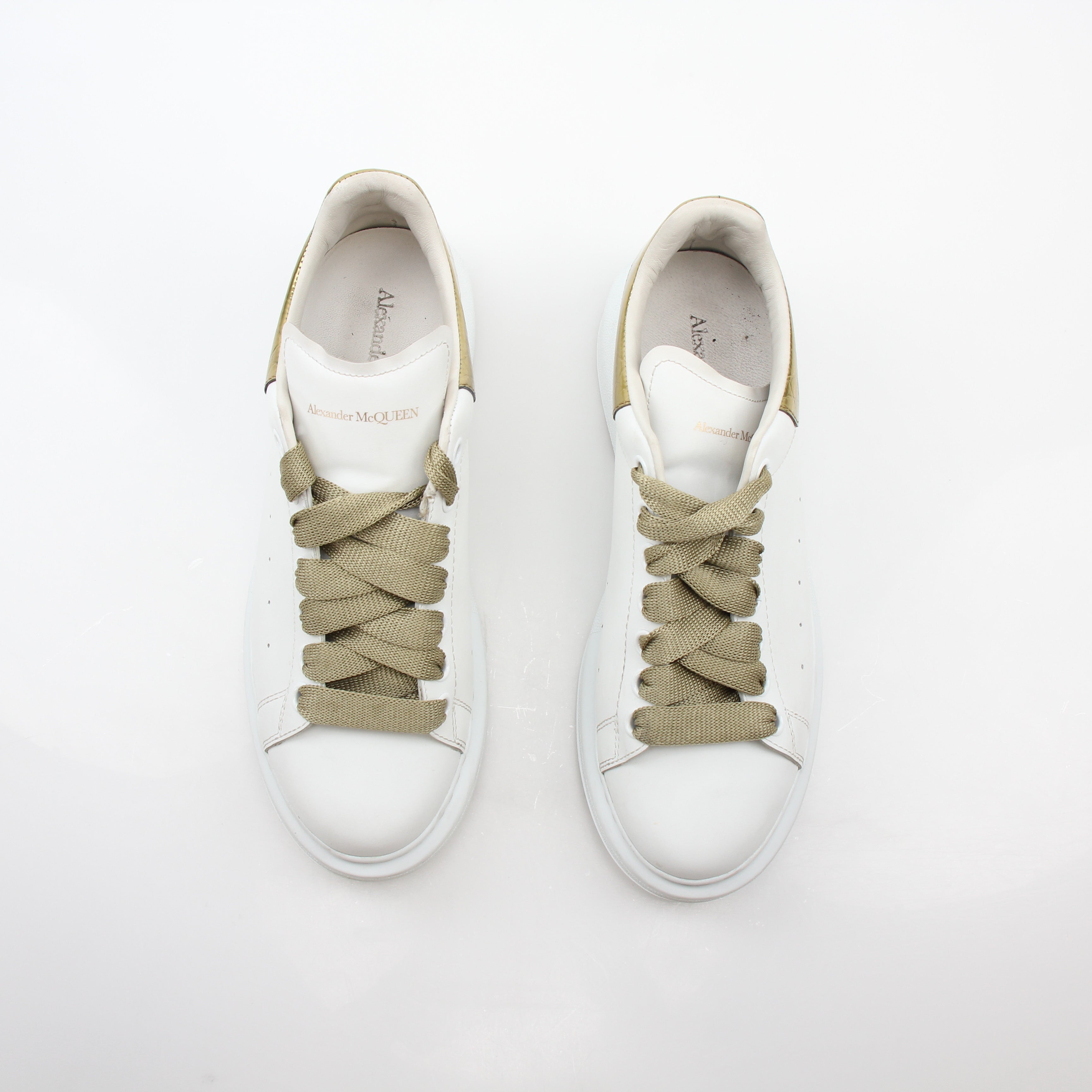 Alexander McQueen white gold oversized low-top sneakers by Gold & Beyond, featuring a sleek design with white and gold accents.