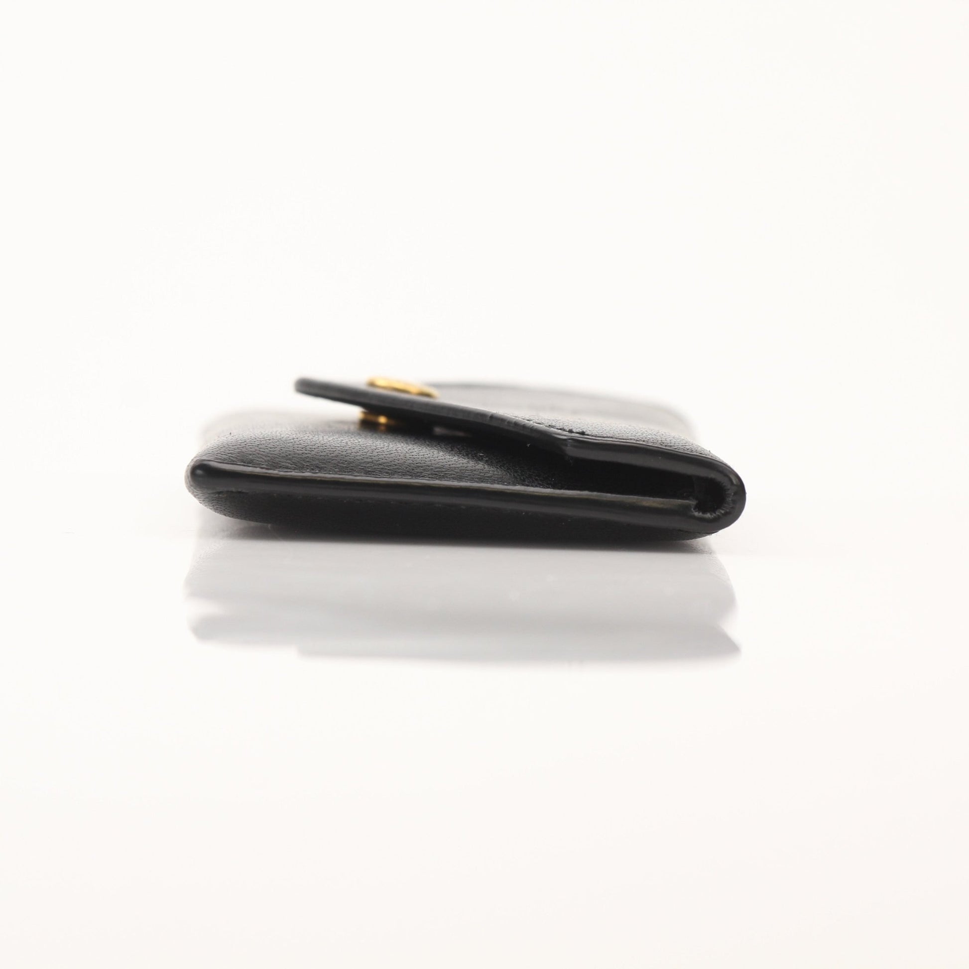 Saint Laurent Loulou lambskin card holder with gold accents, featuring compact design and smooth leather finish.