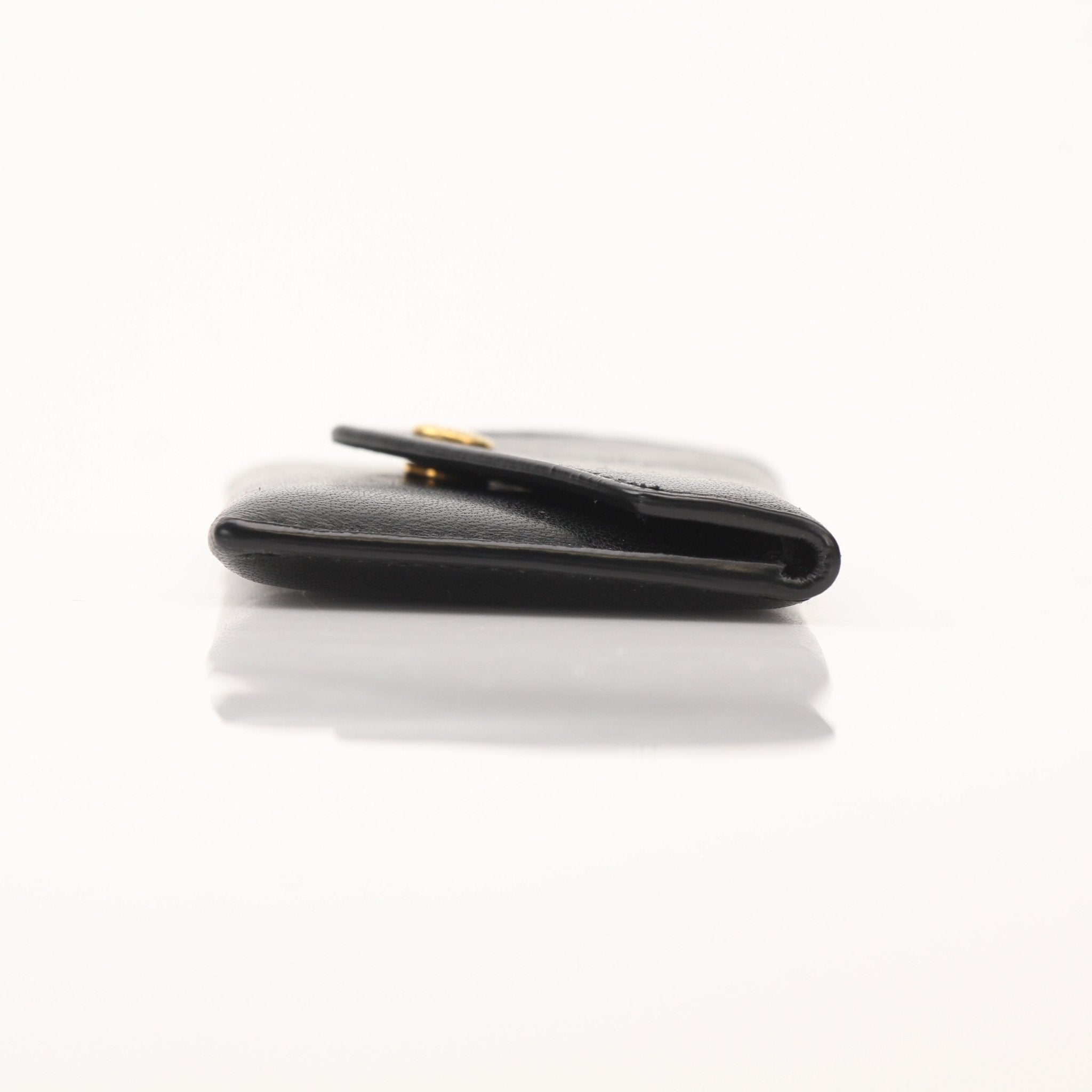 Saint Laurent Loulou lambskin card holder with gold accents, featuring compact design and smooth leather finish.
