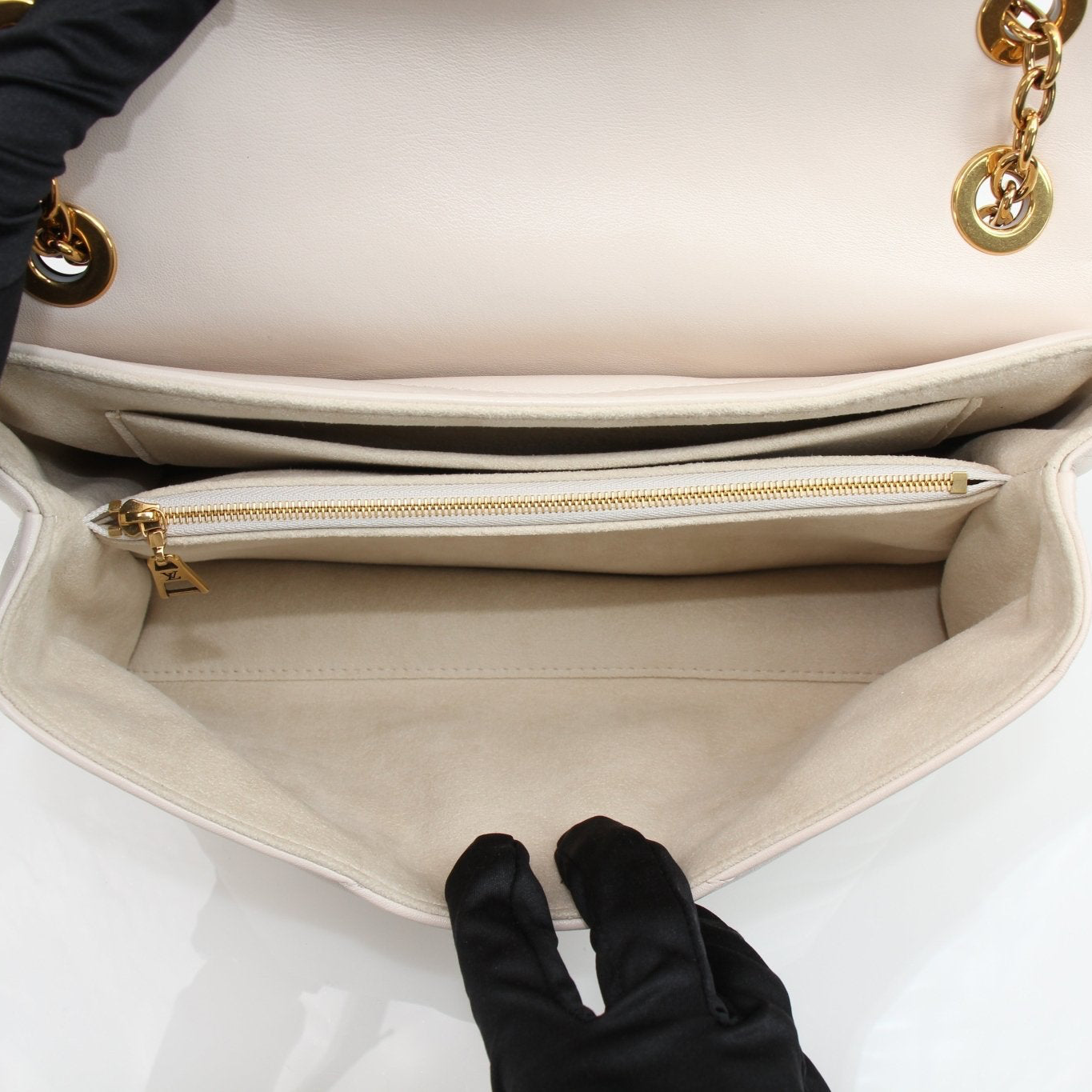 Louis Vuitton New Wave cream chain handbag with gold accents, stylish accessory with textured leather finish.