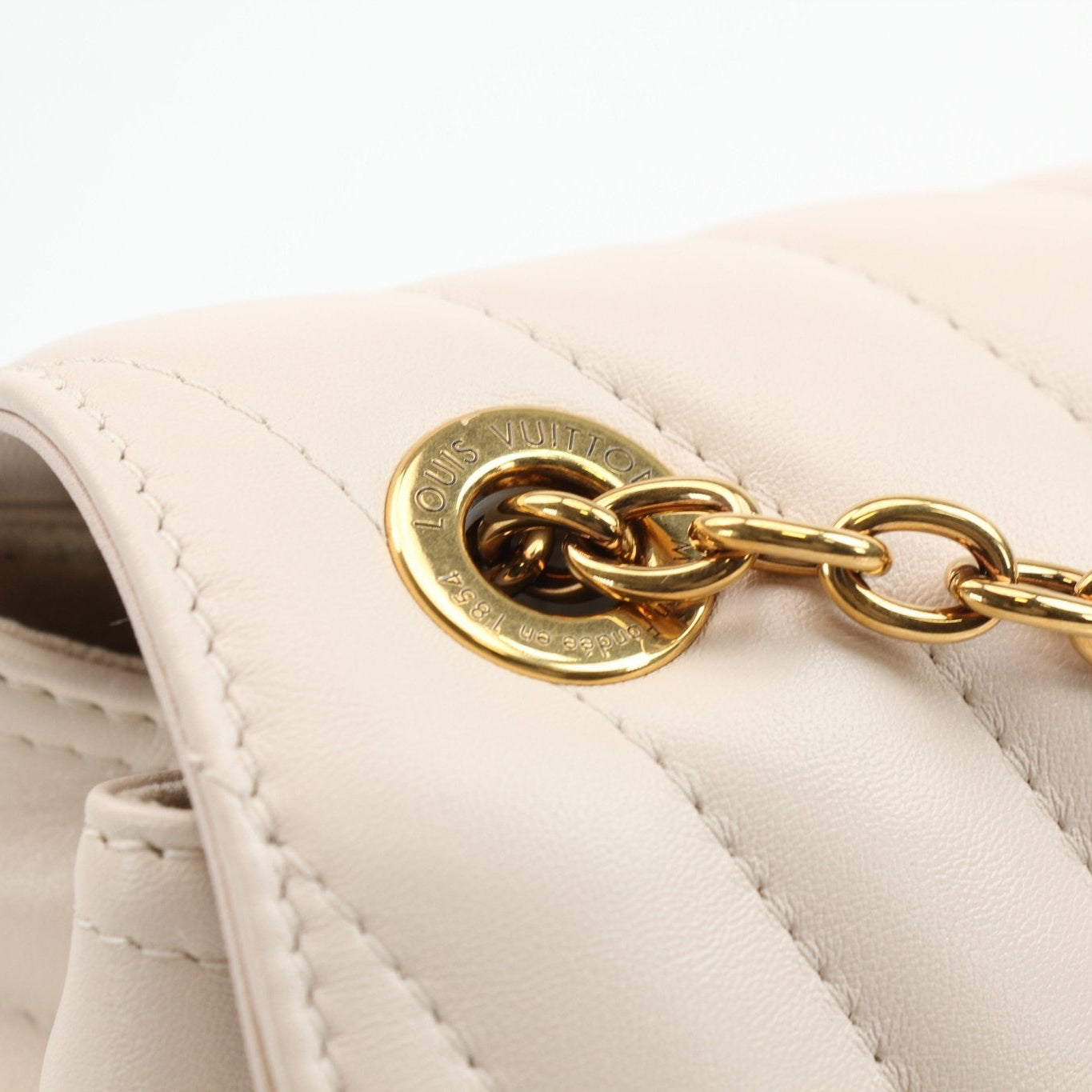 Louis Vuitton New Wave Cream Chain Bag, a stylish handbag with a cream color and gold chain strap from Gold & Beyond.