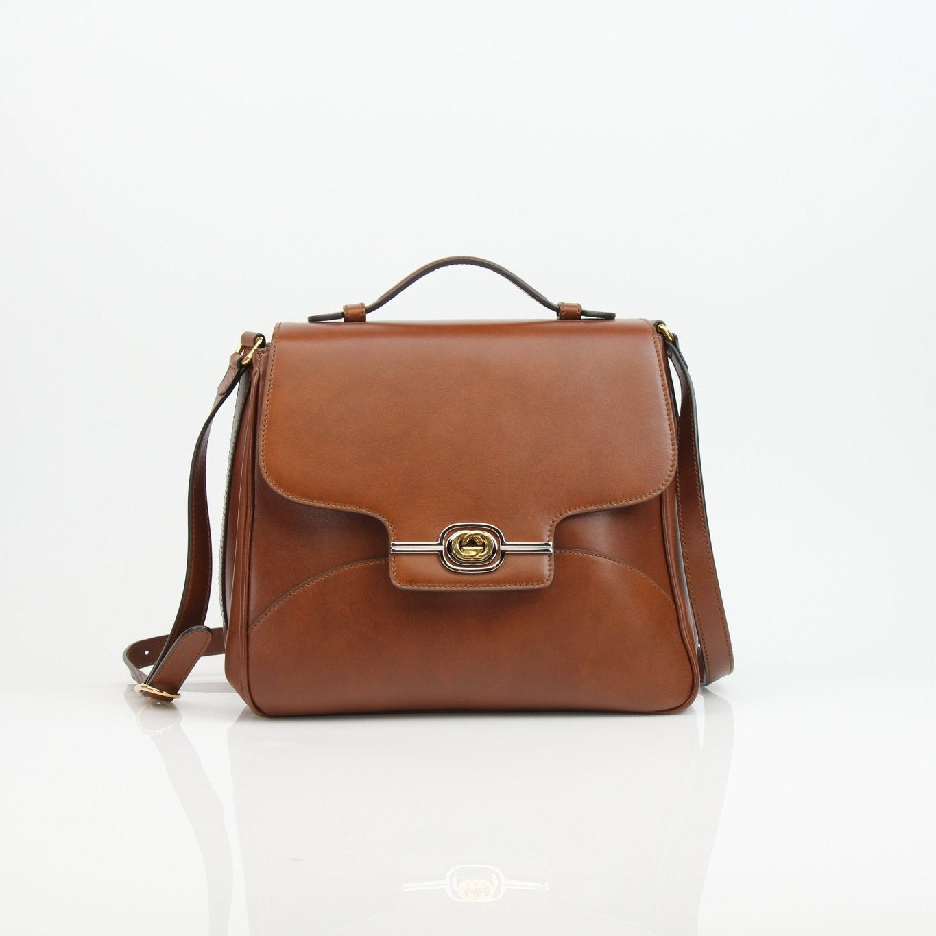 Gucci Pienza brown leather messenger handbag with gold accents, featuring adjustable strap and classic design.