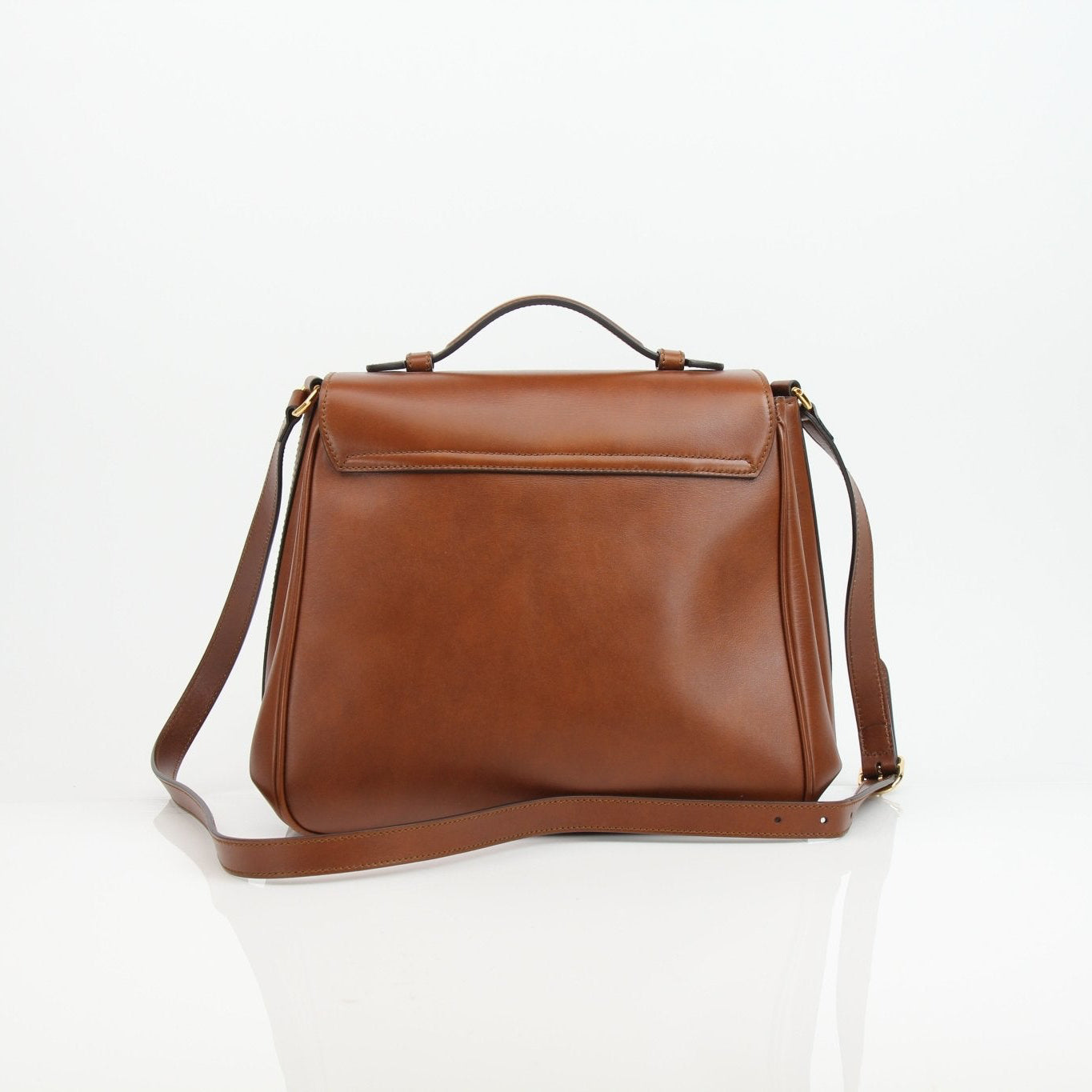 Gucci Pienza brown leather messenger handbag with gold accents, featuring adjustable strap and classic design.
