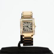Gold & Beyond Cartier Tank Française diamond watch with rectangular gold case and elegant black leather strap.