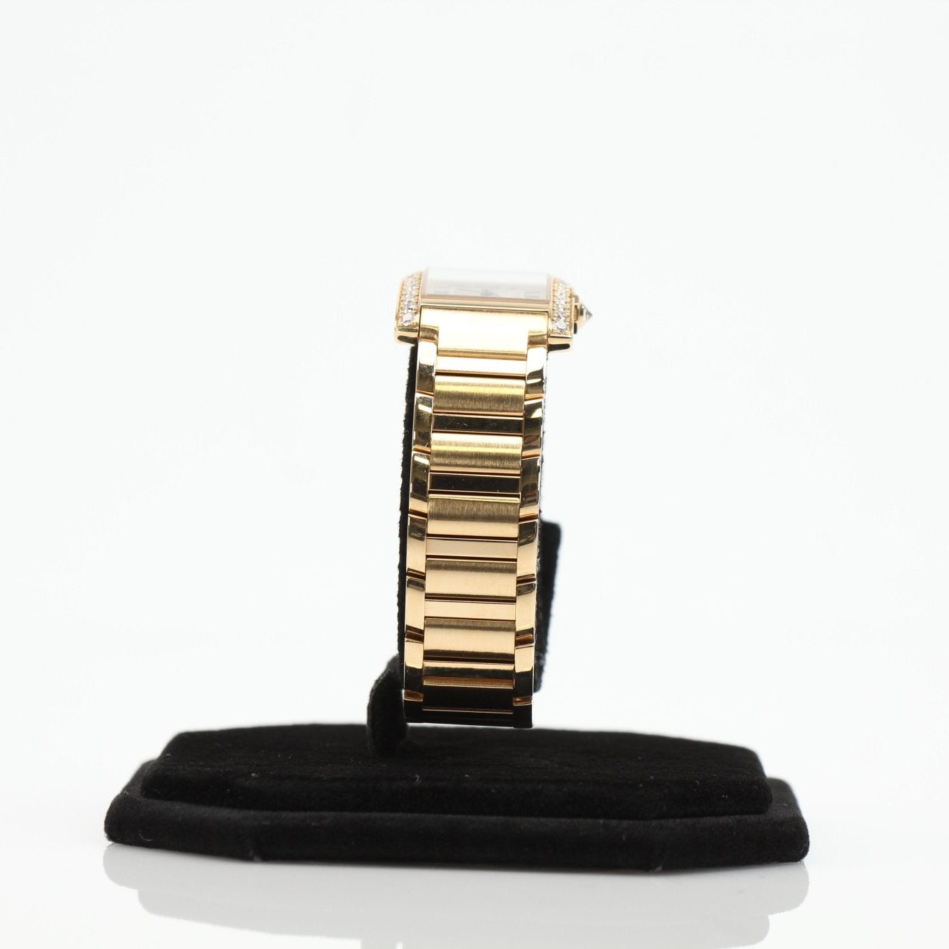 Cartier Tank Française diamond watch with gold bracelet and rectangular face, showcasing elegant luxury design.