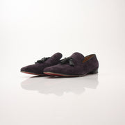 Christian Louboutin Men’s Dandelion Tassel Loafers in black leather with tassel details and signature red soles.