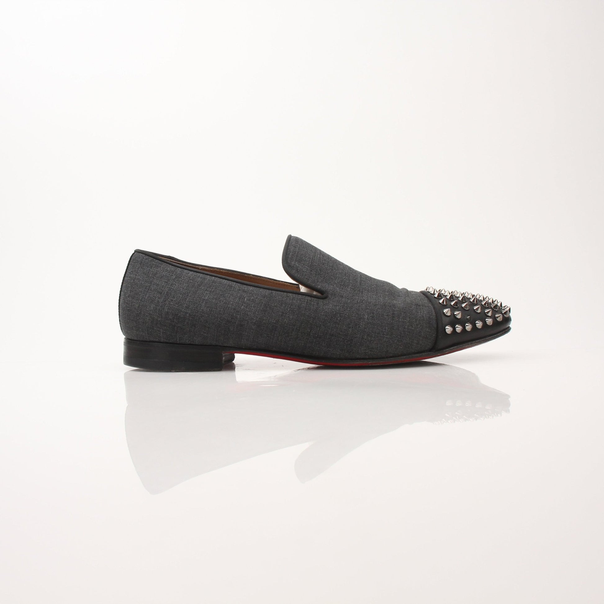 Christian Louboutin men's Spooky Spike flat loafers featuring black leather and distinctive spike embellishments.