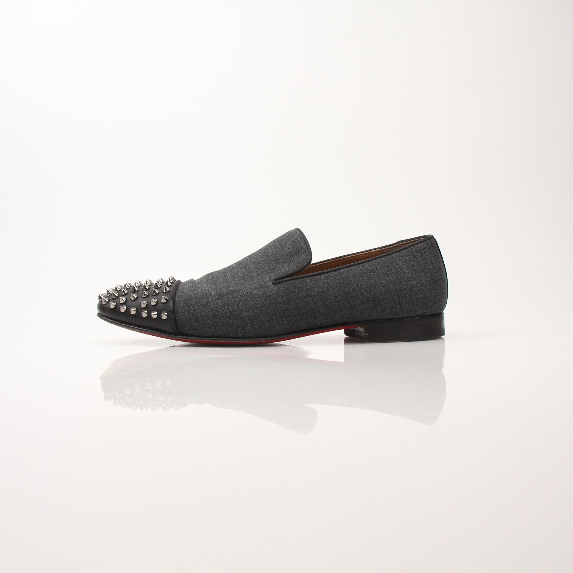 Christian Louboutin men's spooky spike flat loafers featuring black leather with red sole and decorative spike details.