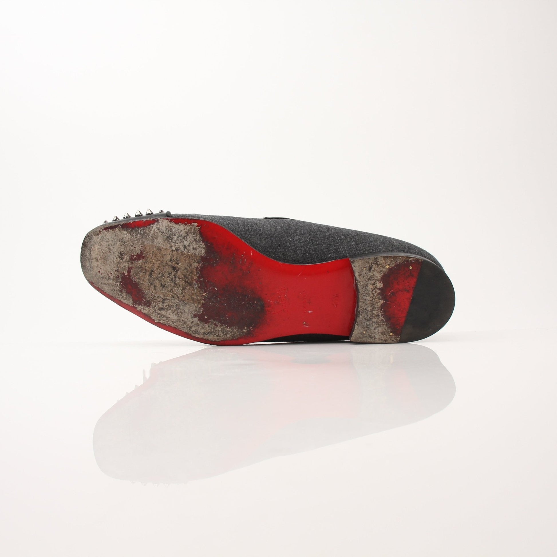 Christian Louboutin men's Spooky Spike flat loafers with black leather and spiked detailing, showcased on a neutral background.
