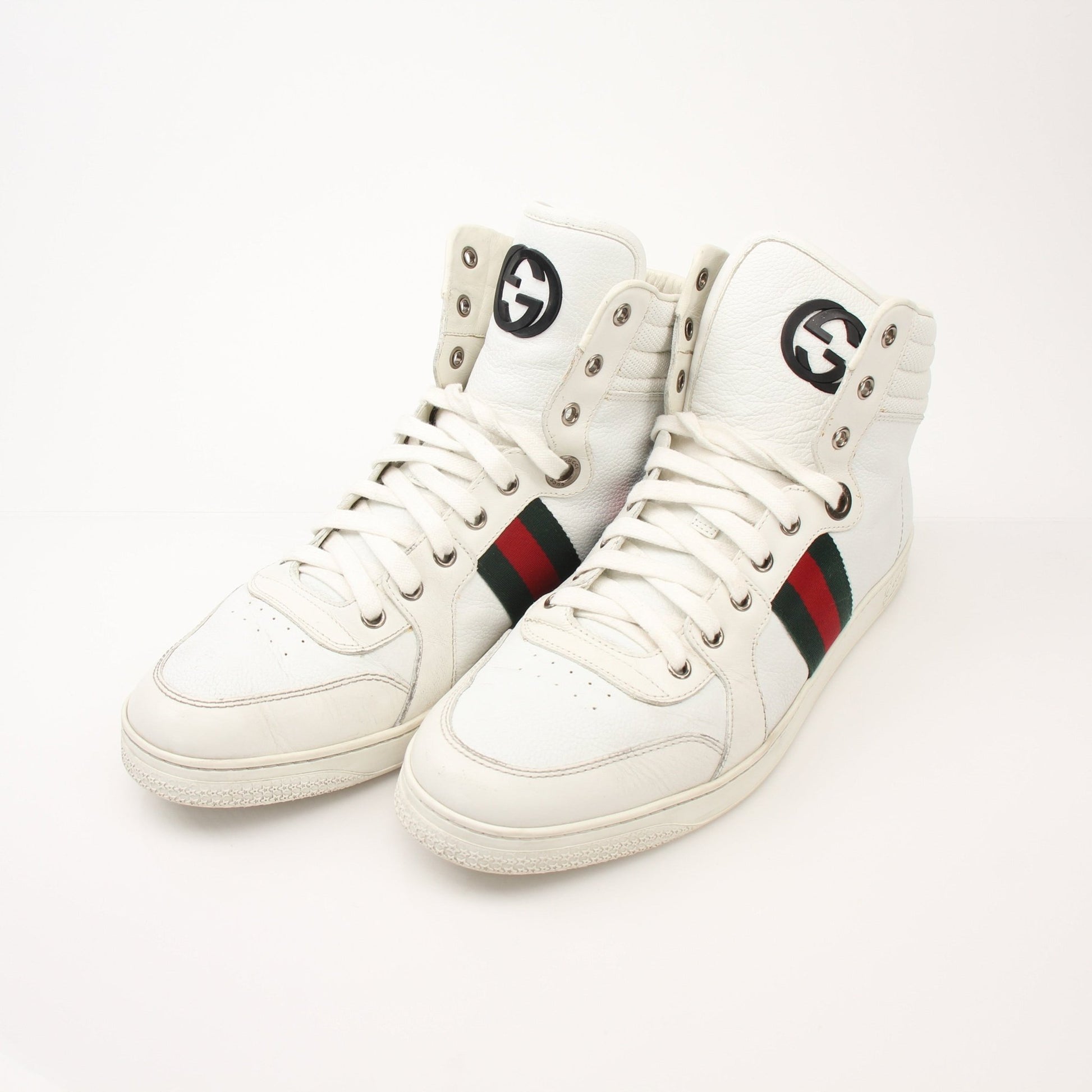 Gold & Beyond men's Gucci Signature high-top sneakers featuring black leather, beige accents, and white rubber soles.