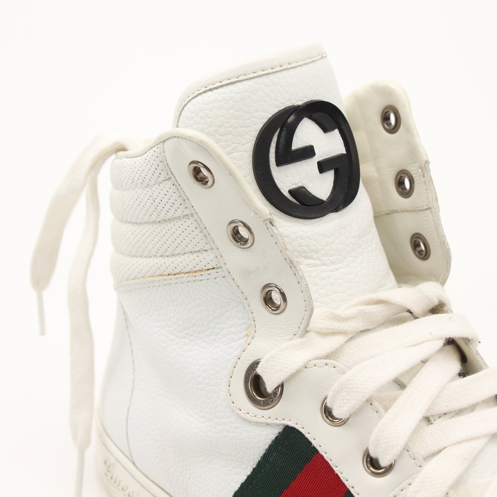 Gold & Beyond Gucci men's signature high-top sneakers with white and black design, showcasing stylish shoes with laces and brand logo.