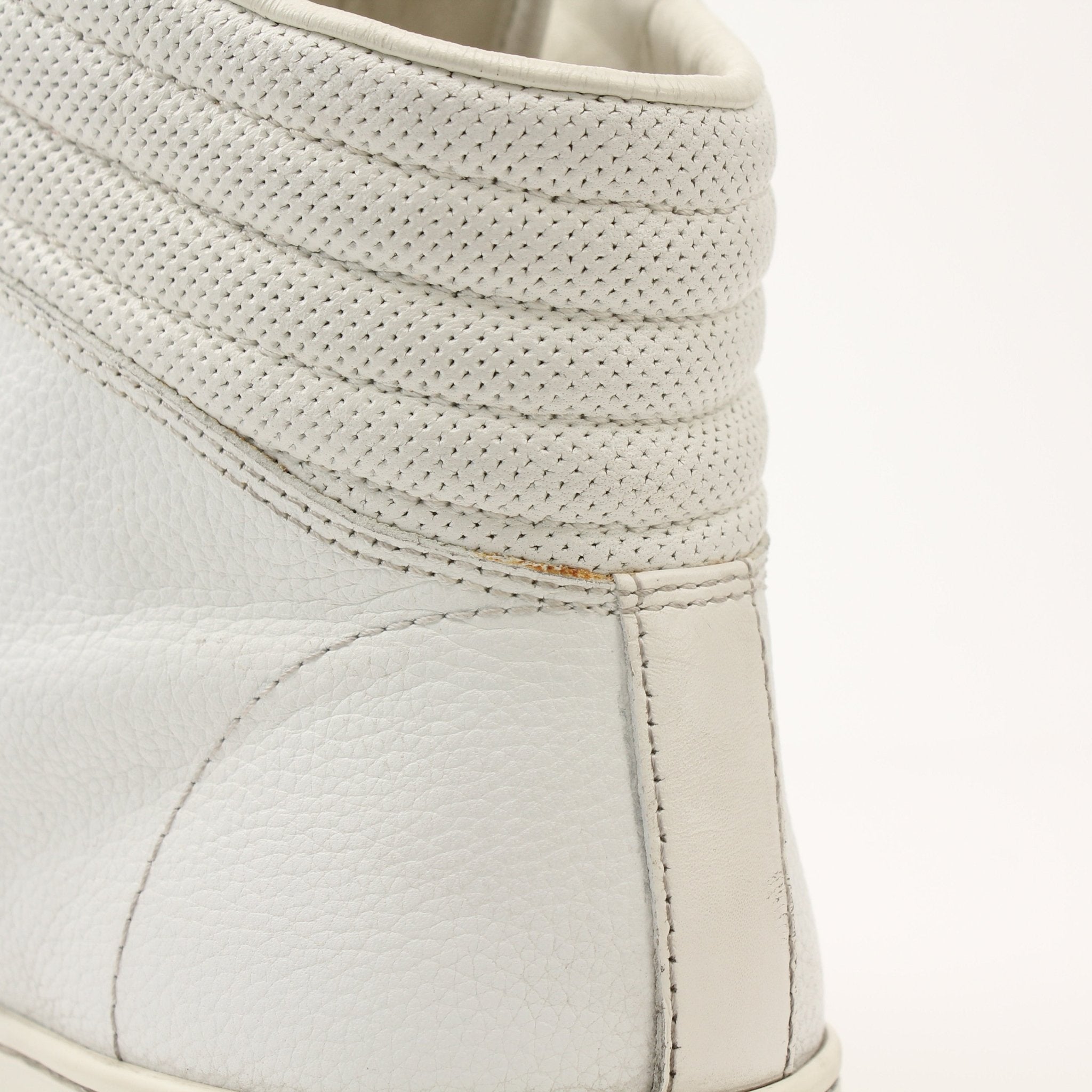 Gold & Beyond Gucci men's signature high-top sneakers with white laces and iconic logo design, showcased from a side angle.