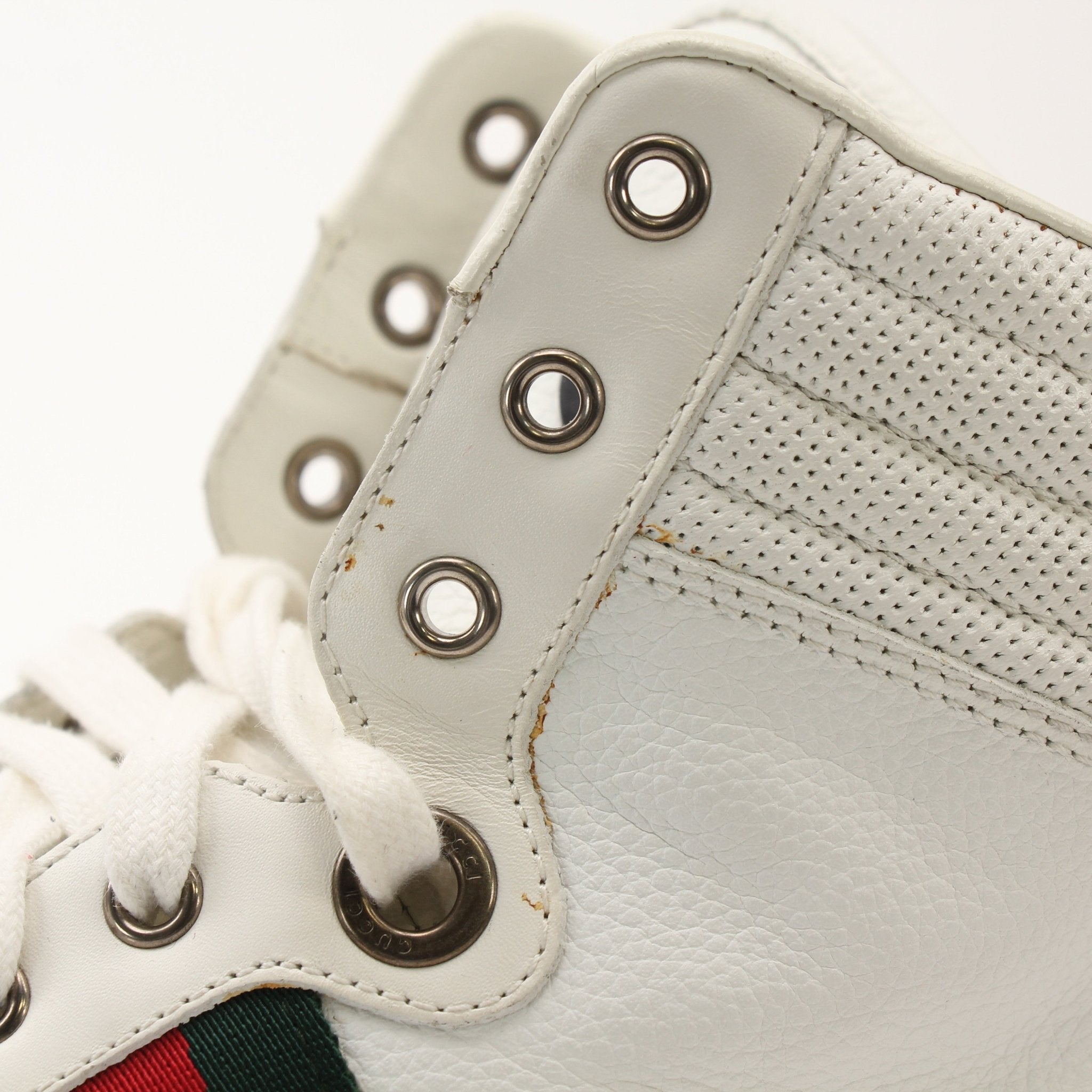 Gold & Beyond Gucci men's signature high-top sneakers with white leather and signature logo, displayed on a plain background.