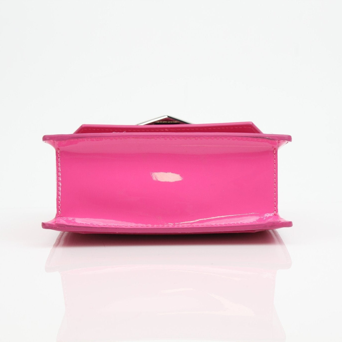 Pink patent top handle handbag by Philipp Plein with gold accents, styled with a sleek design and structured shape.