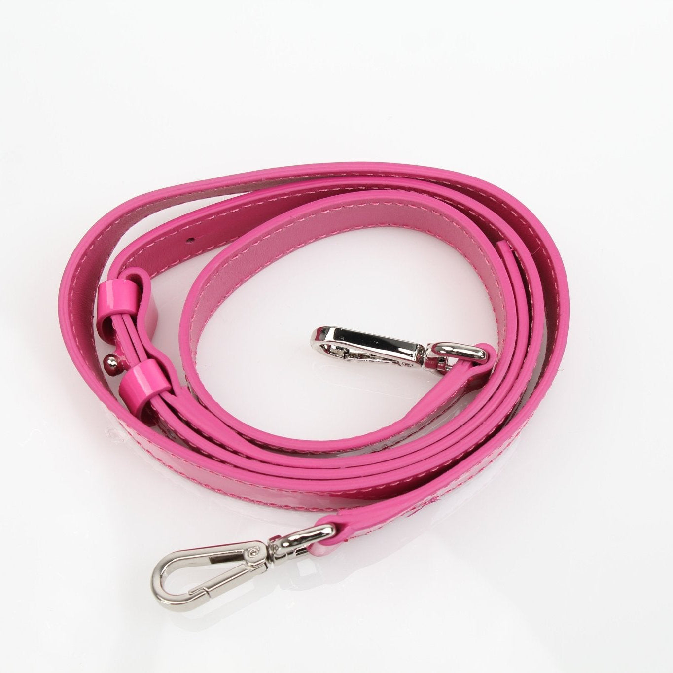 Pink patent top handle handbag by Philipp Plein with gold accents, featuring a sleek and stylish design.