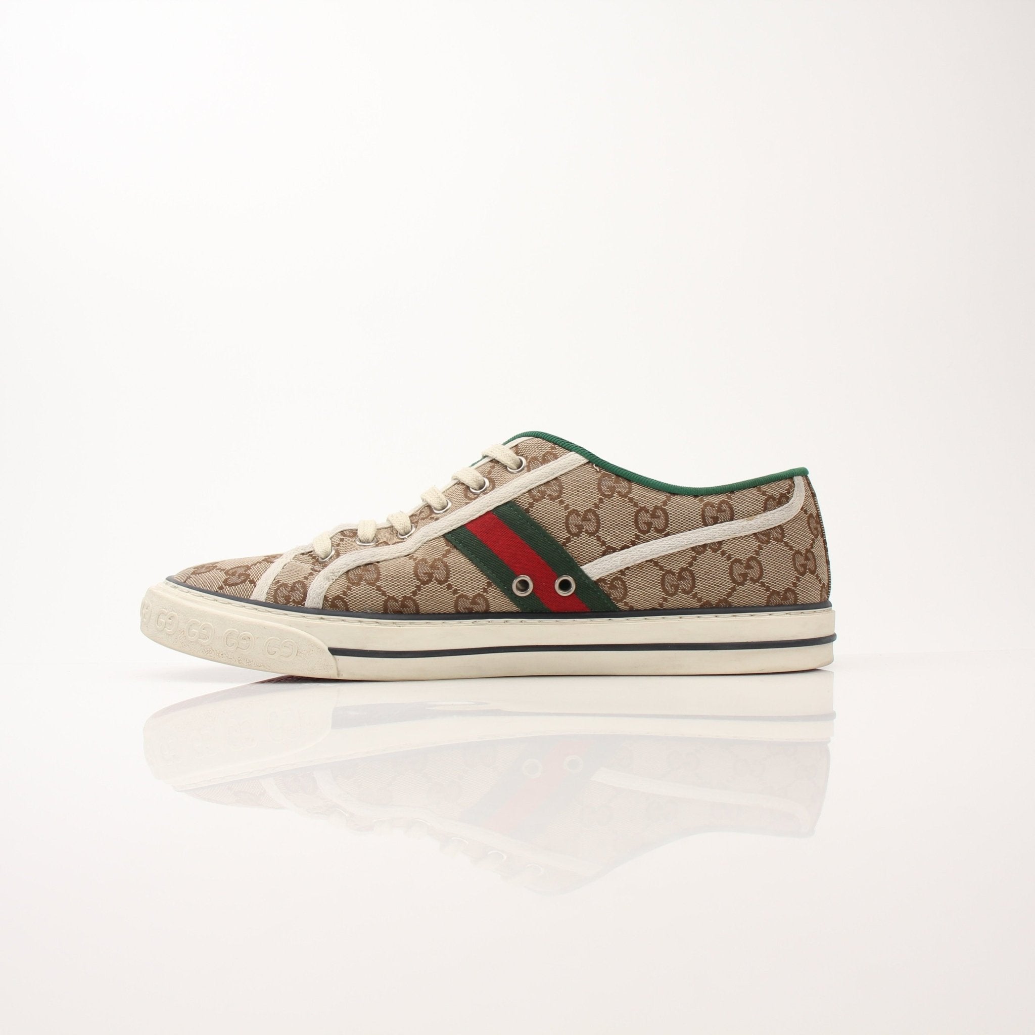 Gold & Beyond Gucci men's GG Tennis 1977 low-top sneakers with black leather and signature logo design.
