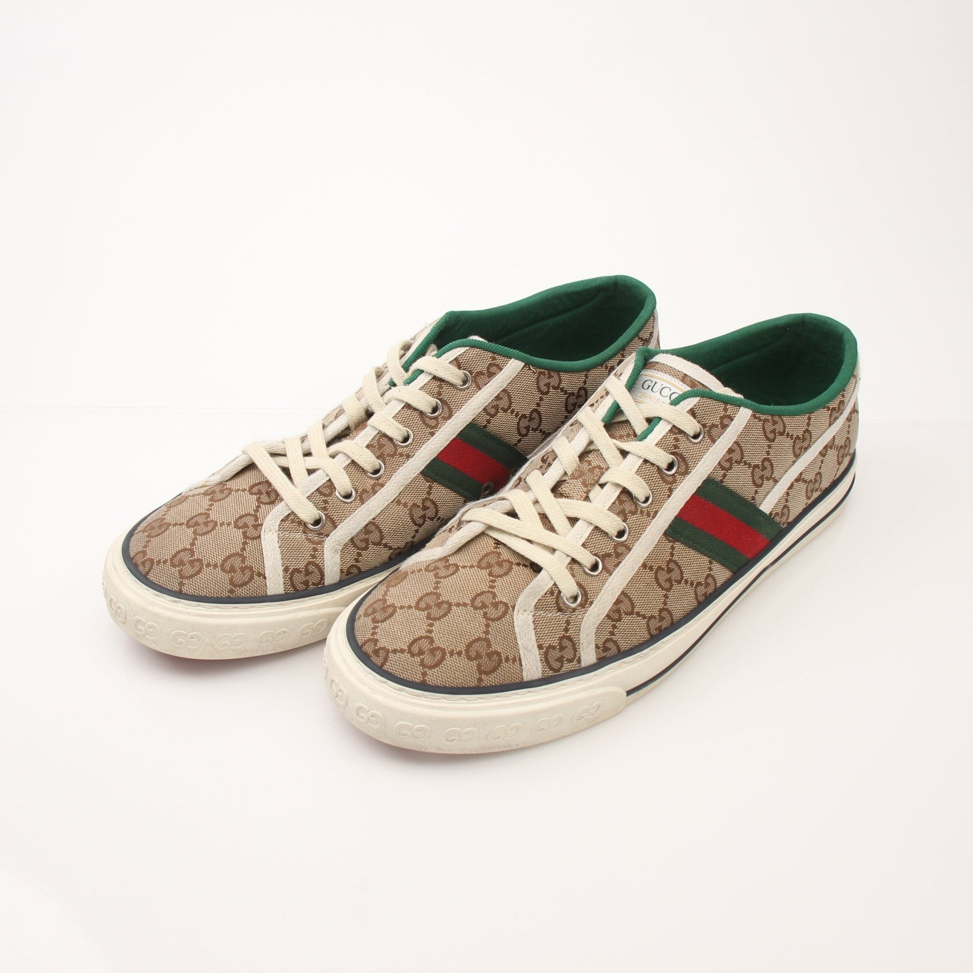 Gold & Beyond Gucci men's GG Tennis 1977 low-top sneakers showing classic design with white laces and signature logo on the side.