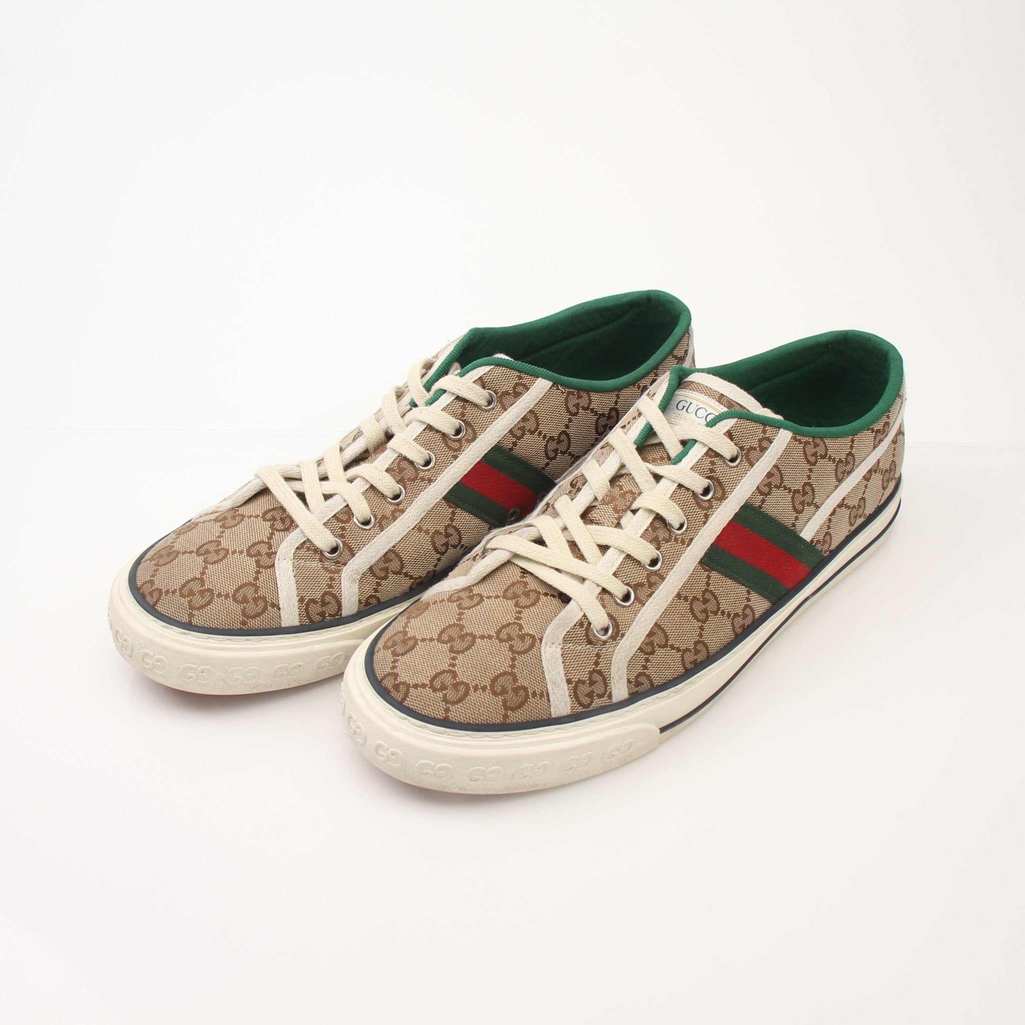 Gold & Beyond Gucci men's GG Tennis 1977 low-top sneakers showing classic design with white laces and signature logo on the side.
