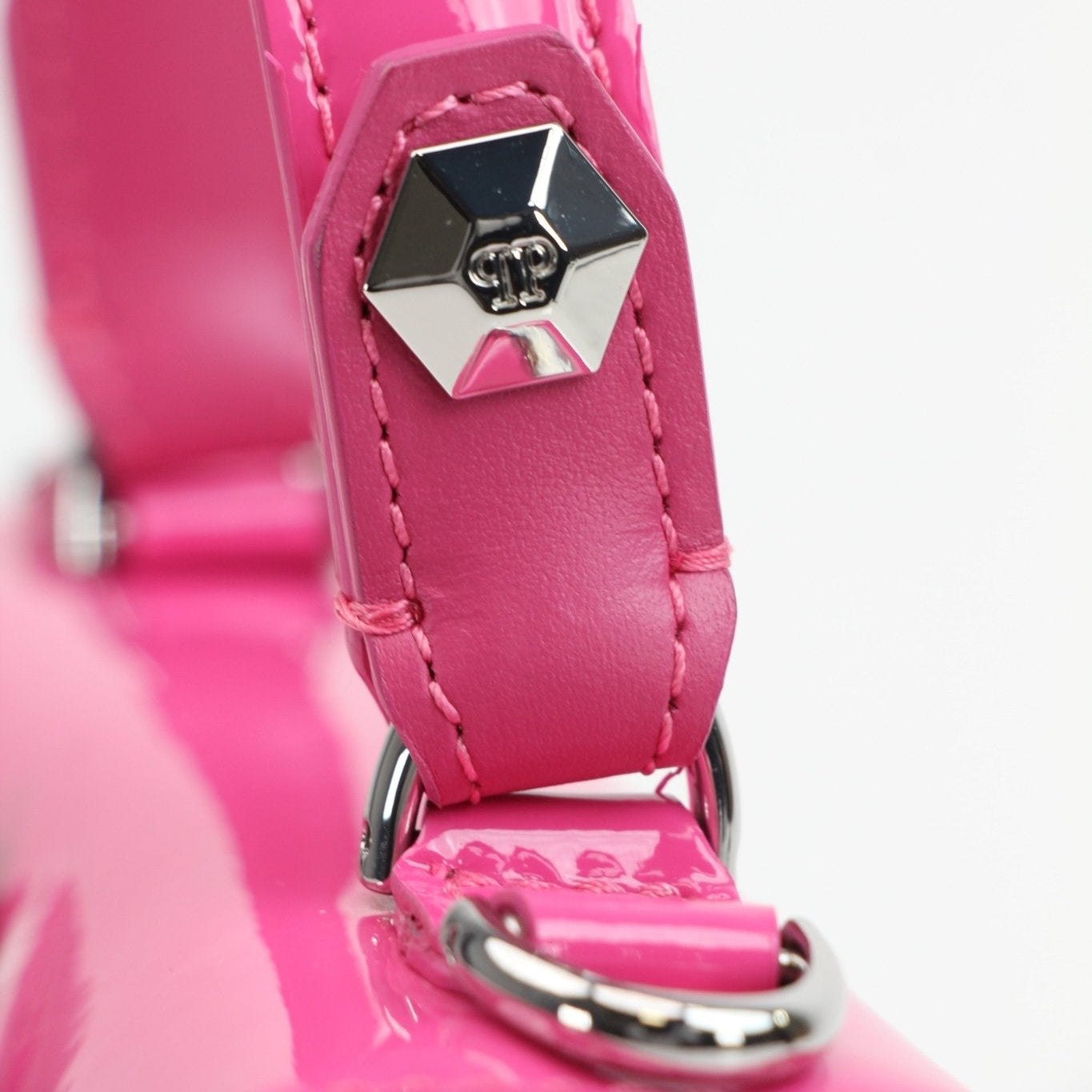 Pink patent top handle handbag by Philipp Plein with gold accents, featuring a sleek and stylish design.