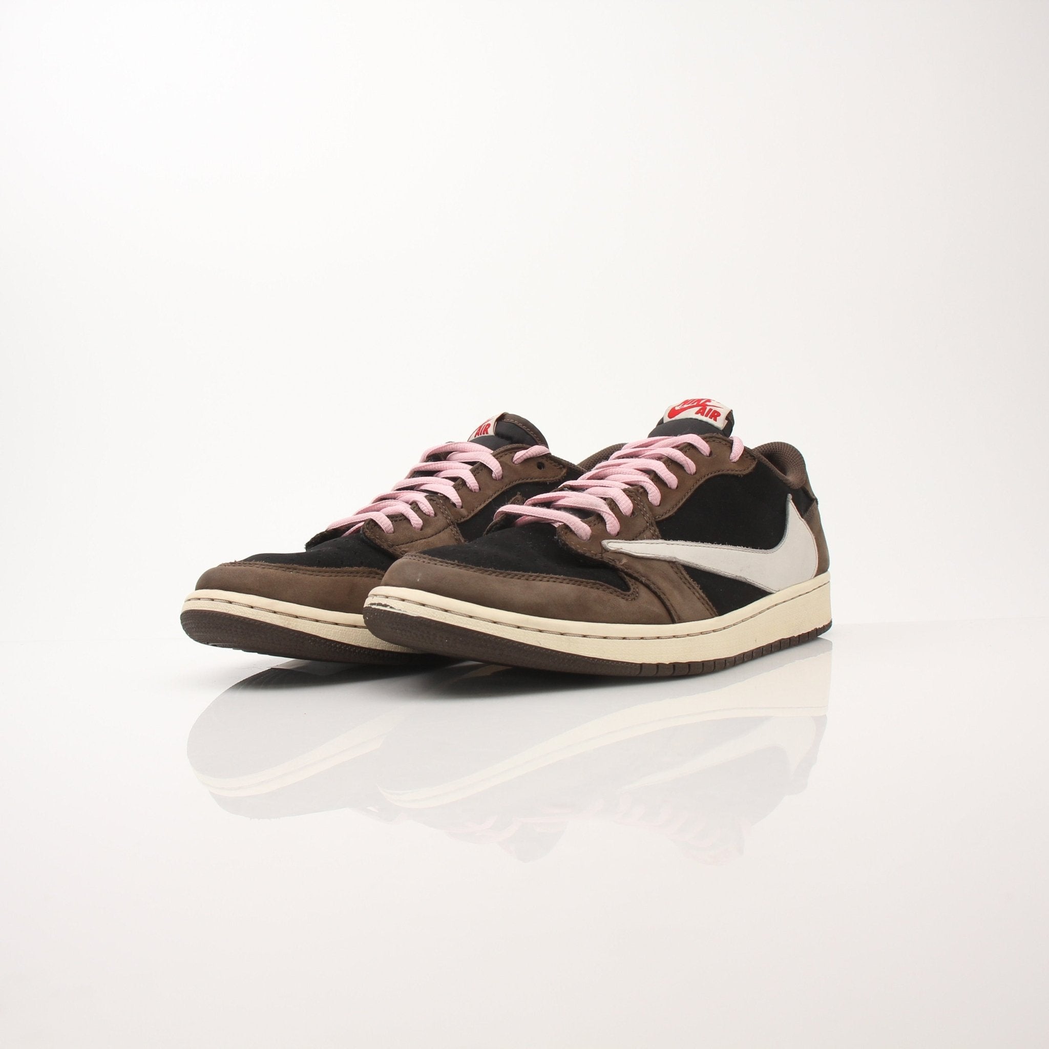 Gold & Beyond Air Jordan X Travis Scott Men's Jordan 1 Low sneakers, side view showing black, brown, and white leather details.