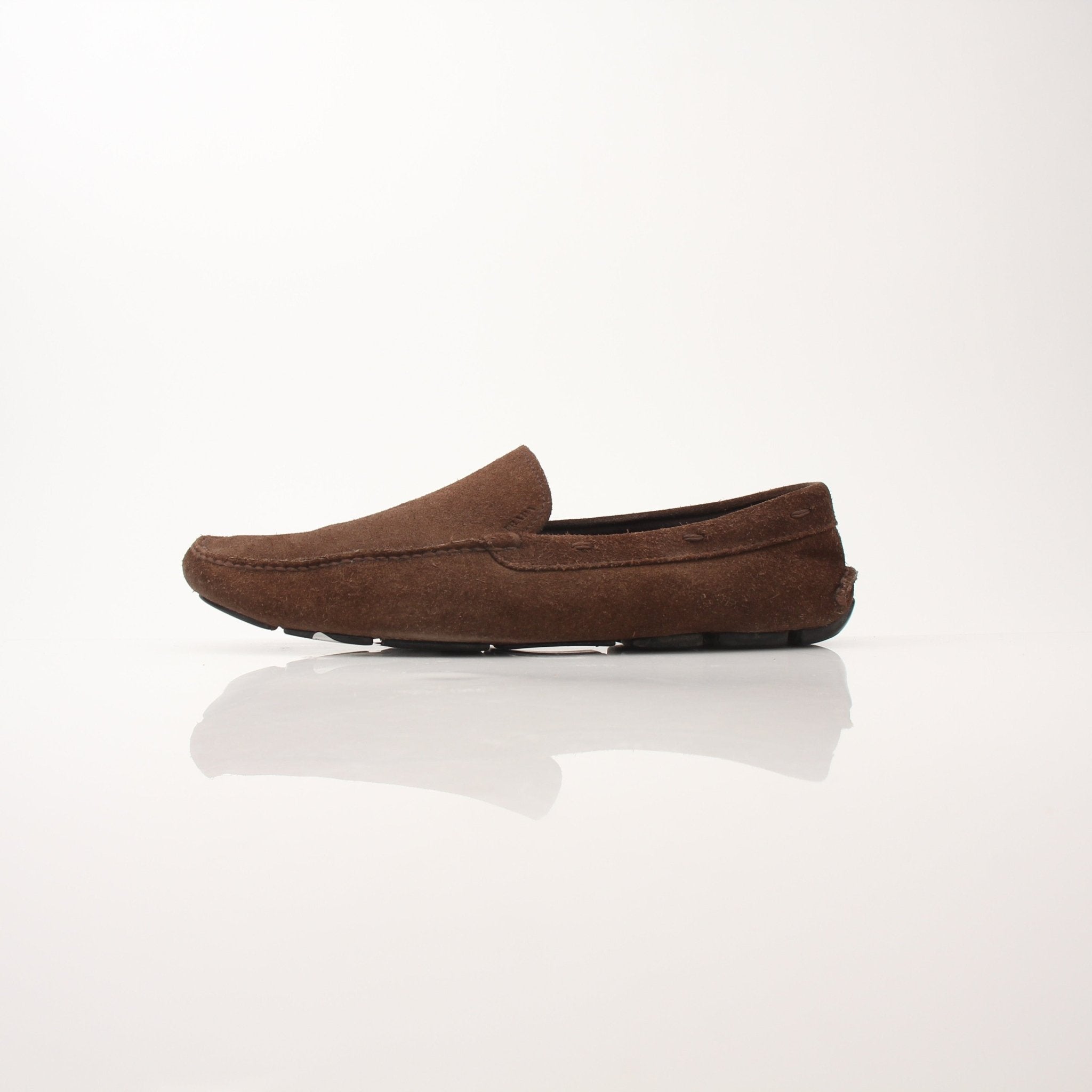 Gold & Beyond Prada men's driving suede loafers showing classic slip-on shoes with smooth suede finish and sleek design.
