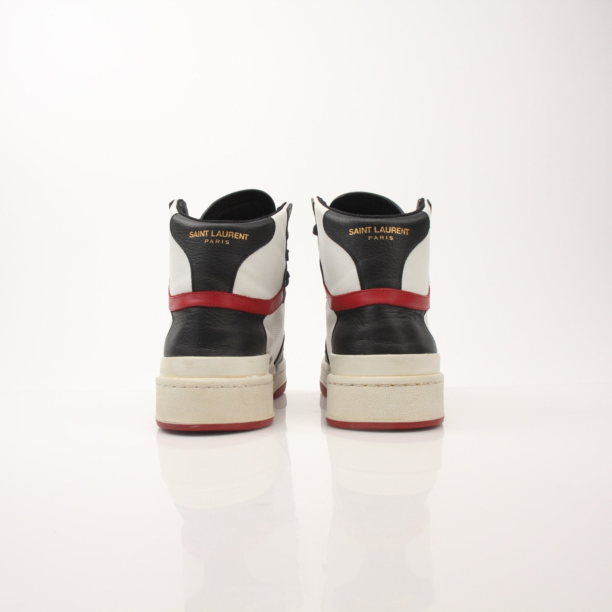 Saint Laurent men's SL-24 leather sneakers with white soles, black leather upper, and minimalist design.