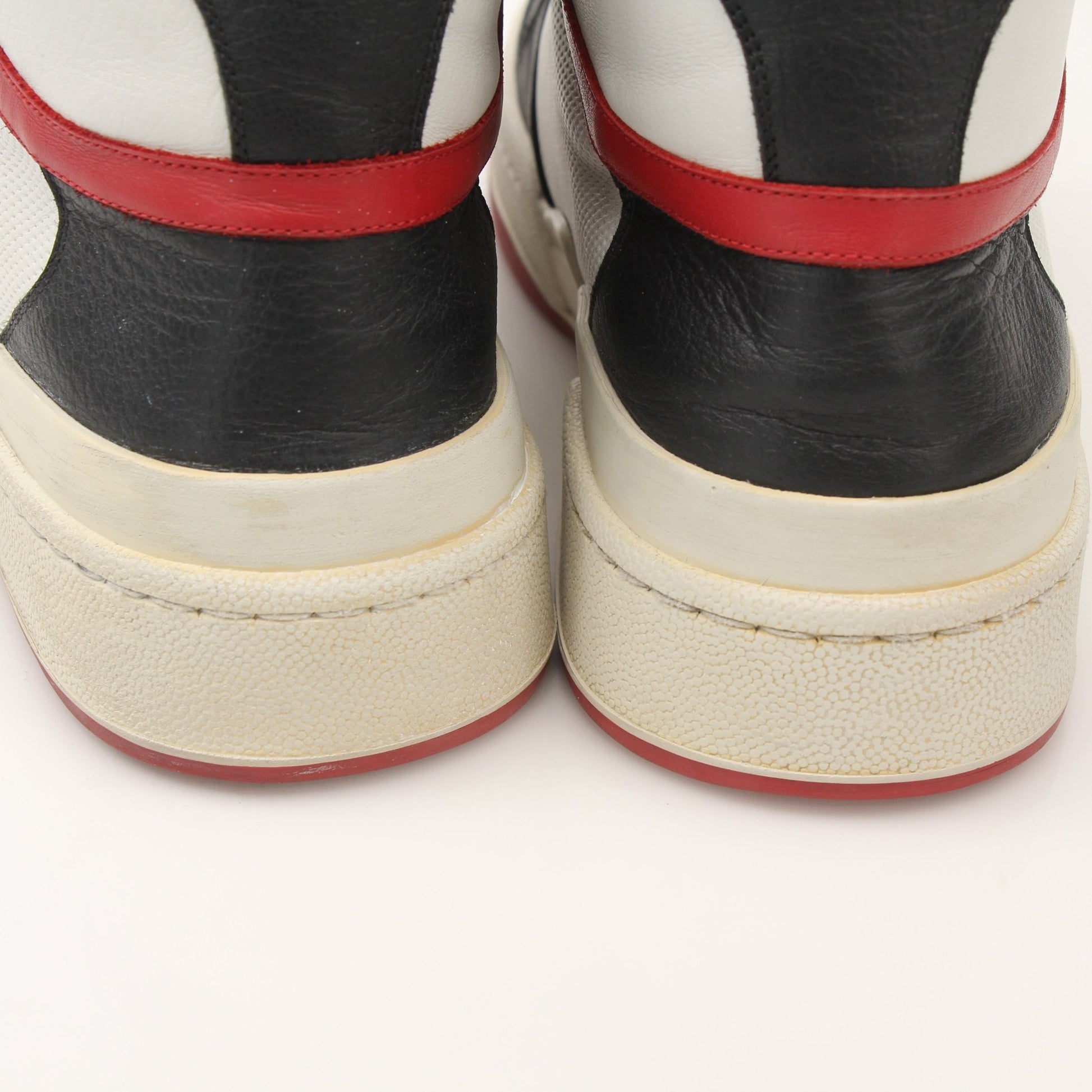 Saint Laurent men's SL-24 leather sneakers featuring sleek black design and minimalist style, shown on a clean white background.