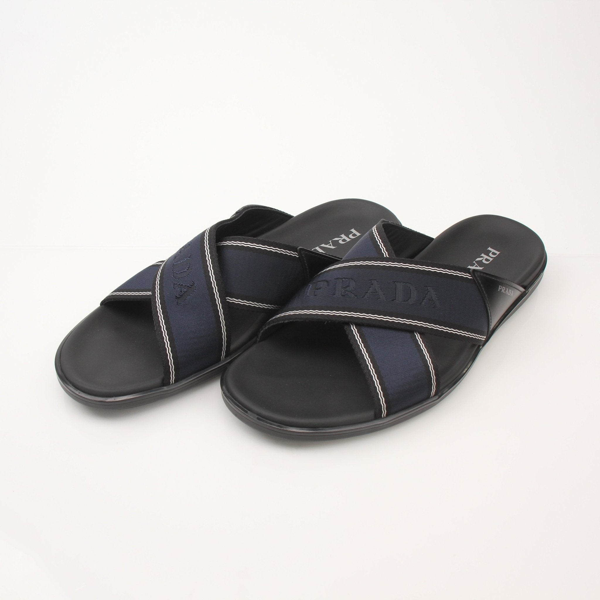 Prada men's leather and Re-Nylon sandals with open toes and adjustable straps, displayed on a neutral background.