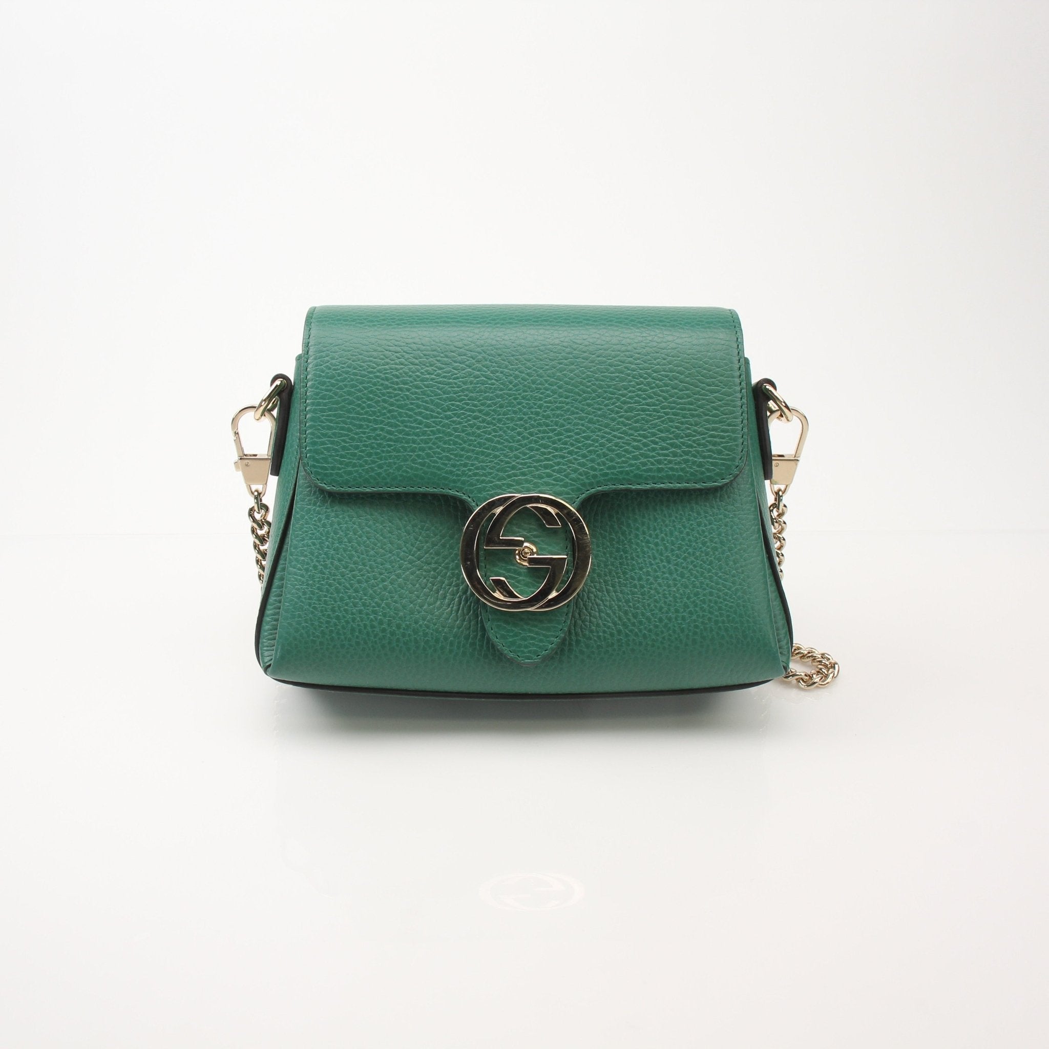 Gold & Beyond Gucci Dollar Calfskin Interlocking G crossbody handbag with sleek design and adjustable strap, featuring signature logo details.