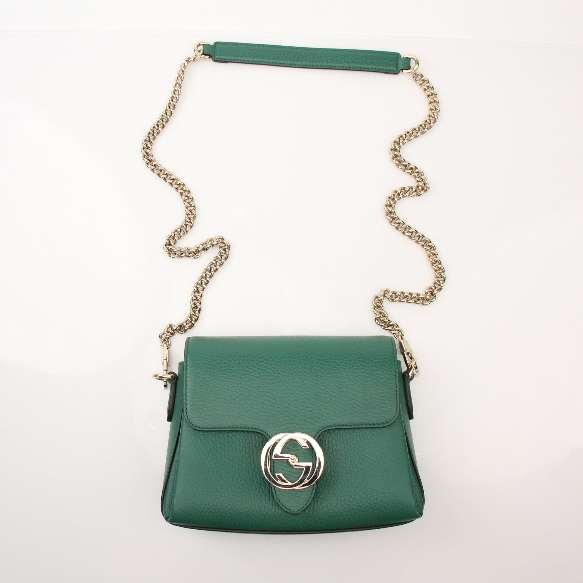 Gucci Dollar calfskin interlocking G crossbody handbag with gold hardware and adjustable strap, featuring classic design details.