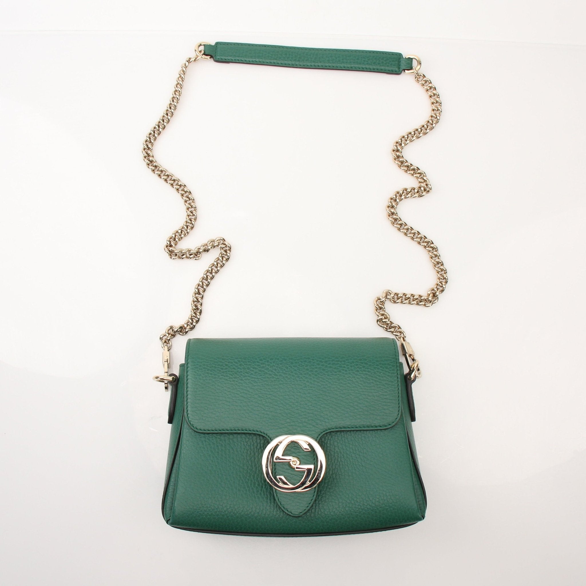Gucci Dollar calfskin interlocking G crossbody handbag with gold hardware and adjustable strap, featuring classic design details.