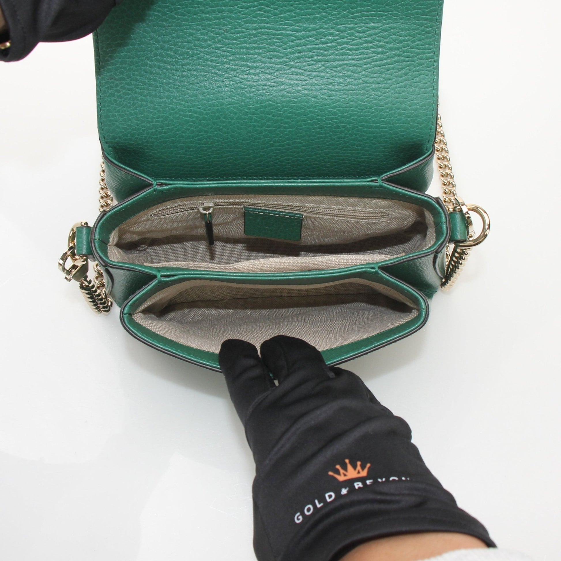 Gucci Dollar Calfskin Interlocking G crossbody handbag with gold hardware and adjustable leather strap.