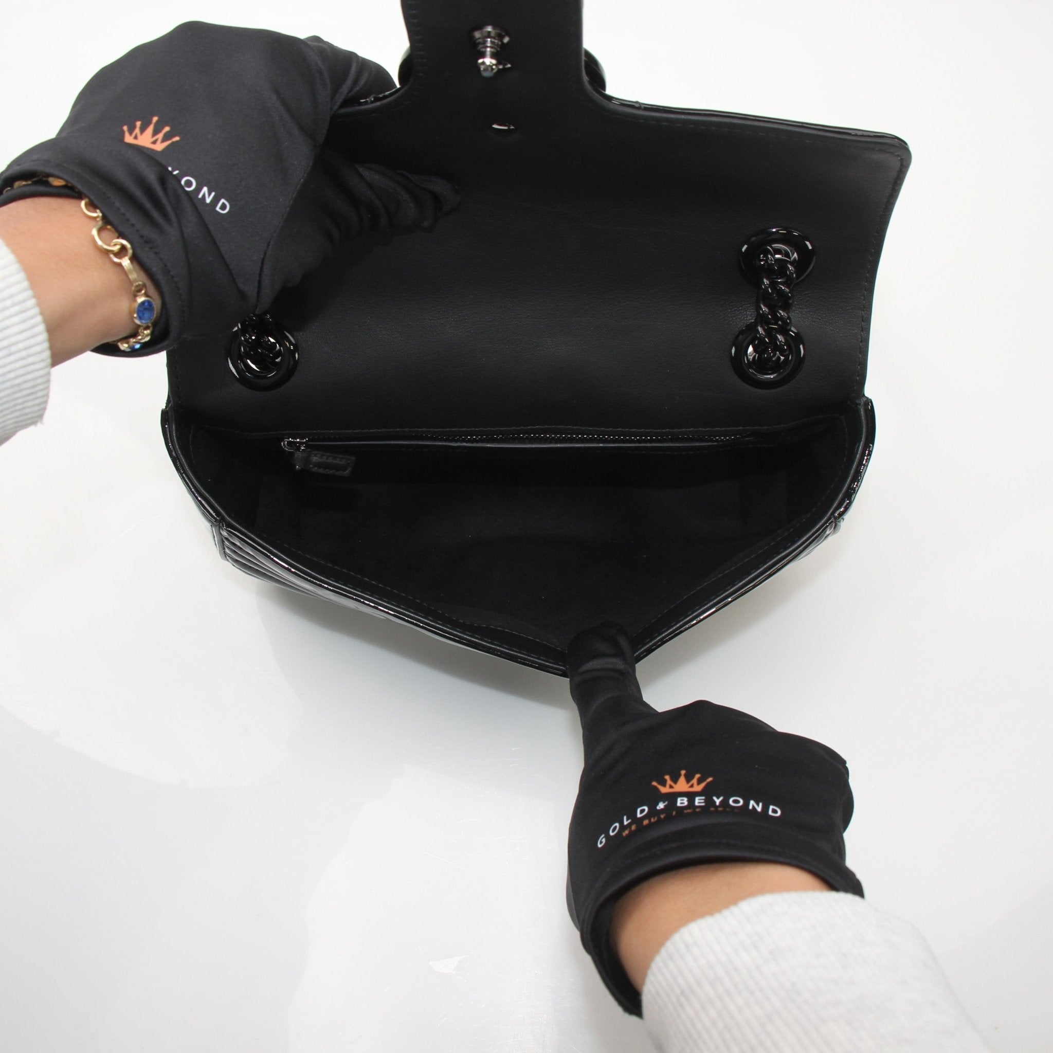Gucci GG Marmont black matelassé shoulder handbag with gold-tone chain strap and chevron quilting, crafted by Gold & Beyond.